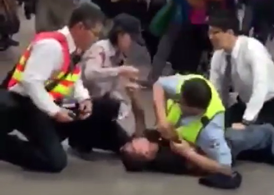 一名疑似精障的男子，進入捷運淡水線時突然攻擊站長，遭現場人員制伏。（翻攝爆料公社）