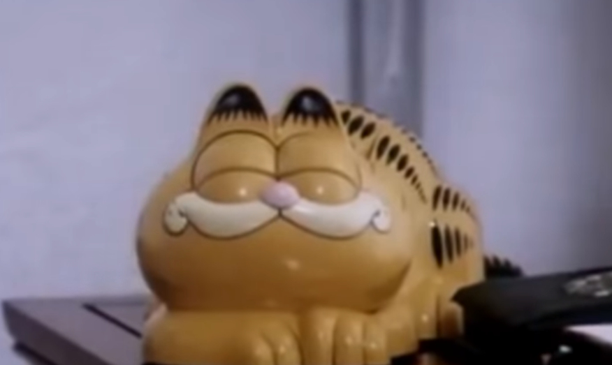 法國布列塔尼的一處海岸從1980年代以來，不斷有加菲貓造型的電話機被沖到海灘上，近日這個謎團終於被解開。（翻攝Youtube）