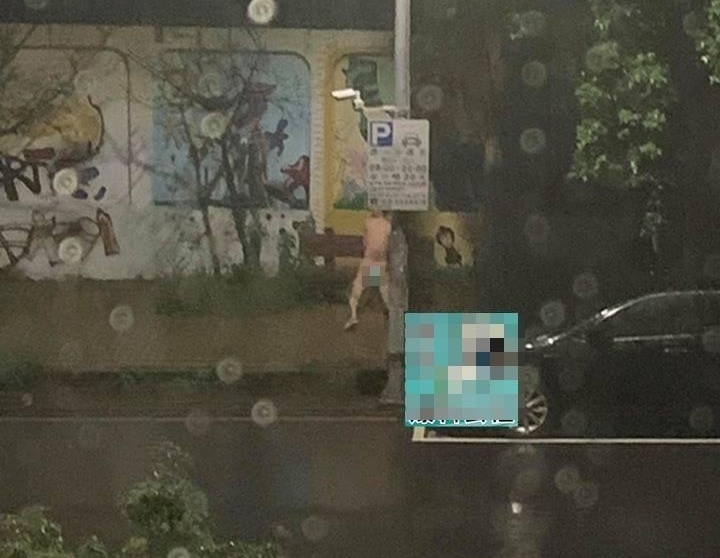 1名男子竟全身赤裸，不畏雨勢跑到市區一所國中旁「猥褻」木製板凳。（翻攝自新竹爆料公社）