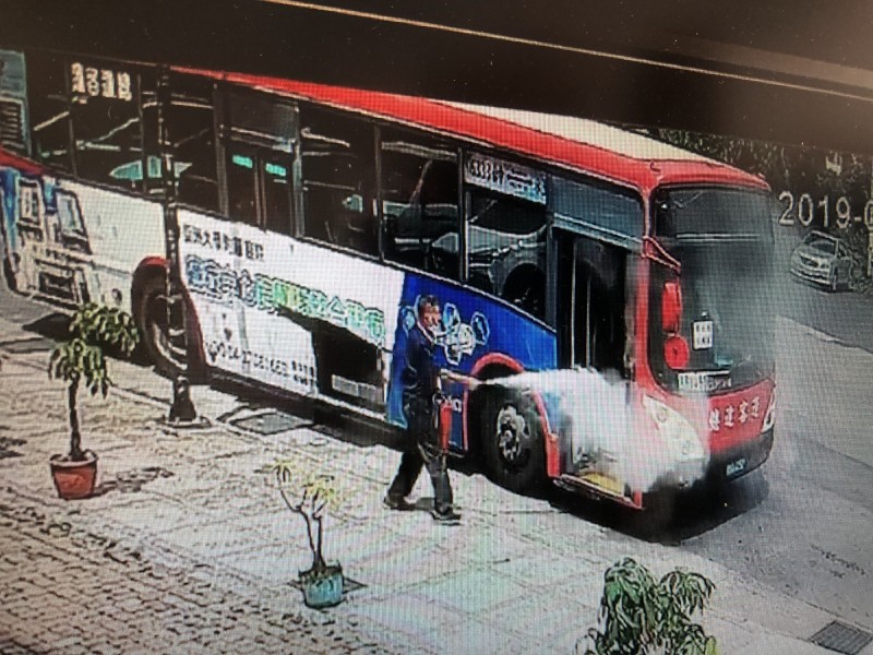 客運突然起火燃燒，附近店家見狀也急忙拿著滅火器協助滅火。（消防局提供）