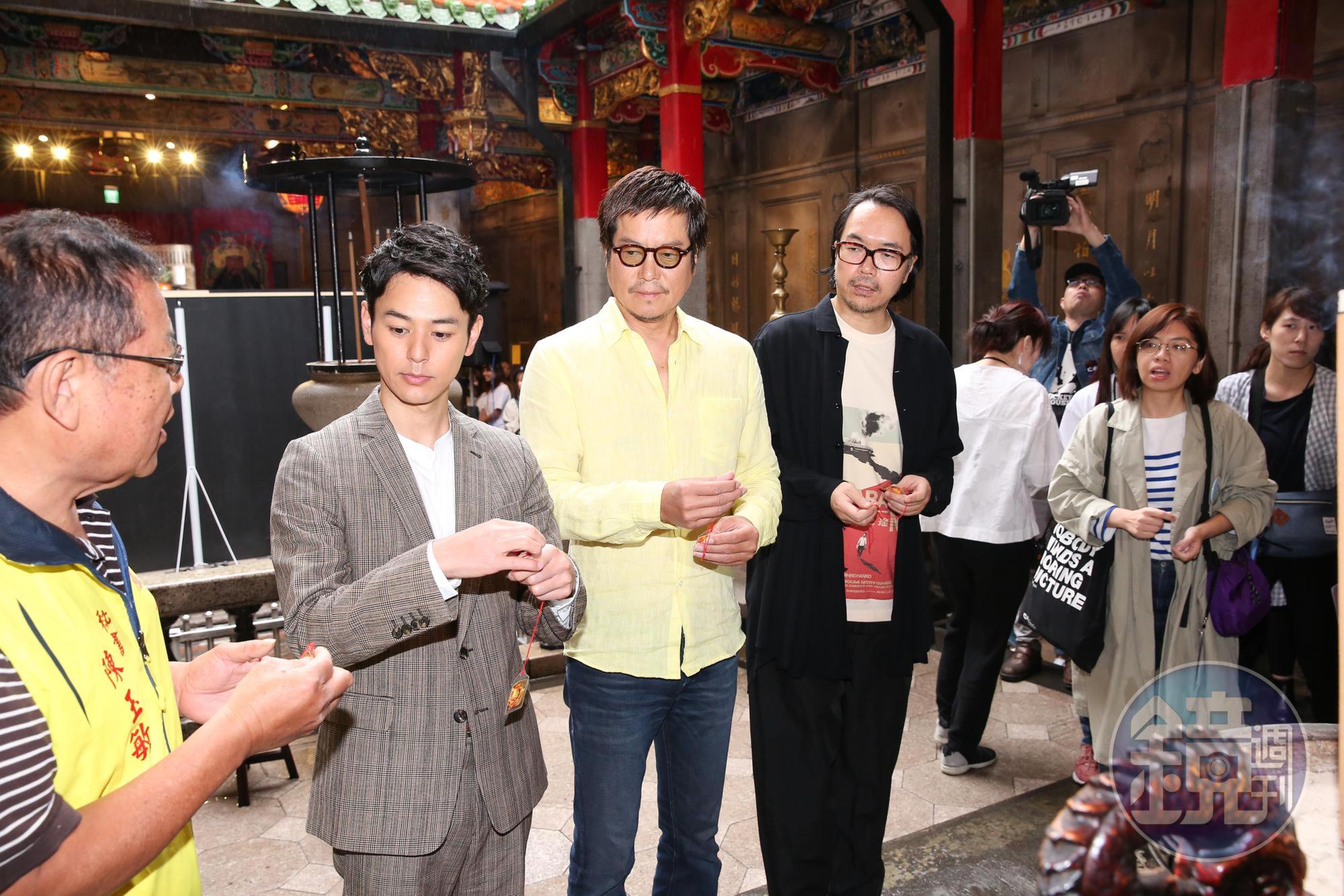 妻夫木聰（左二）、豐川悅司和導演半野喜弘拿著平安符，繞香爐求保祐。