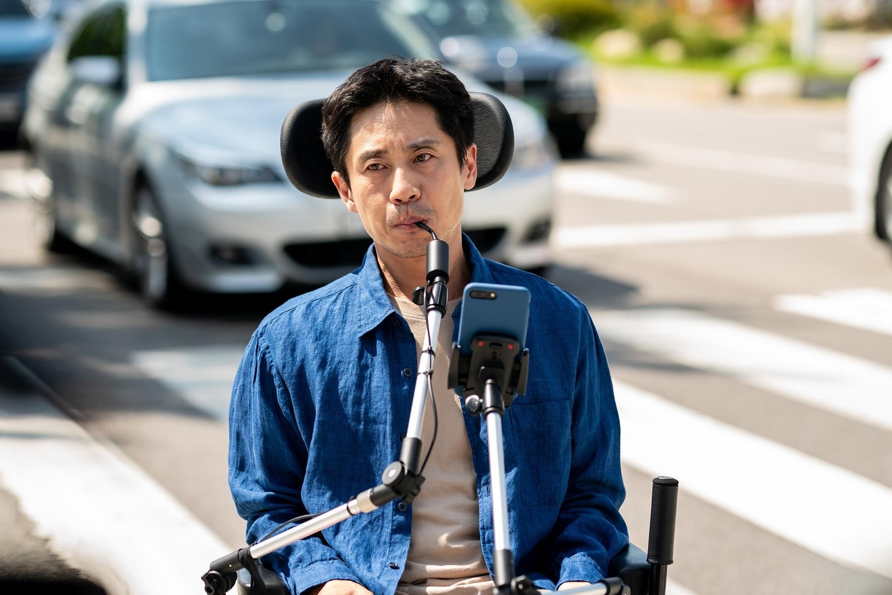 申河均在新片《完美搭檔》飾演肢體障礙者，以嘴巴操控輪椅。（采昌提供）