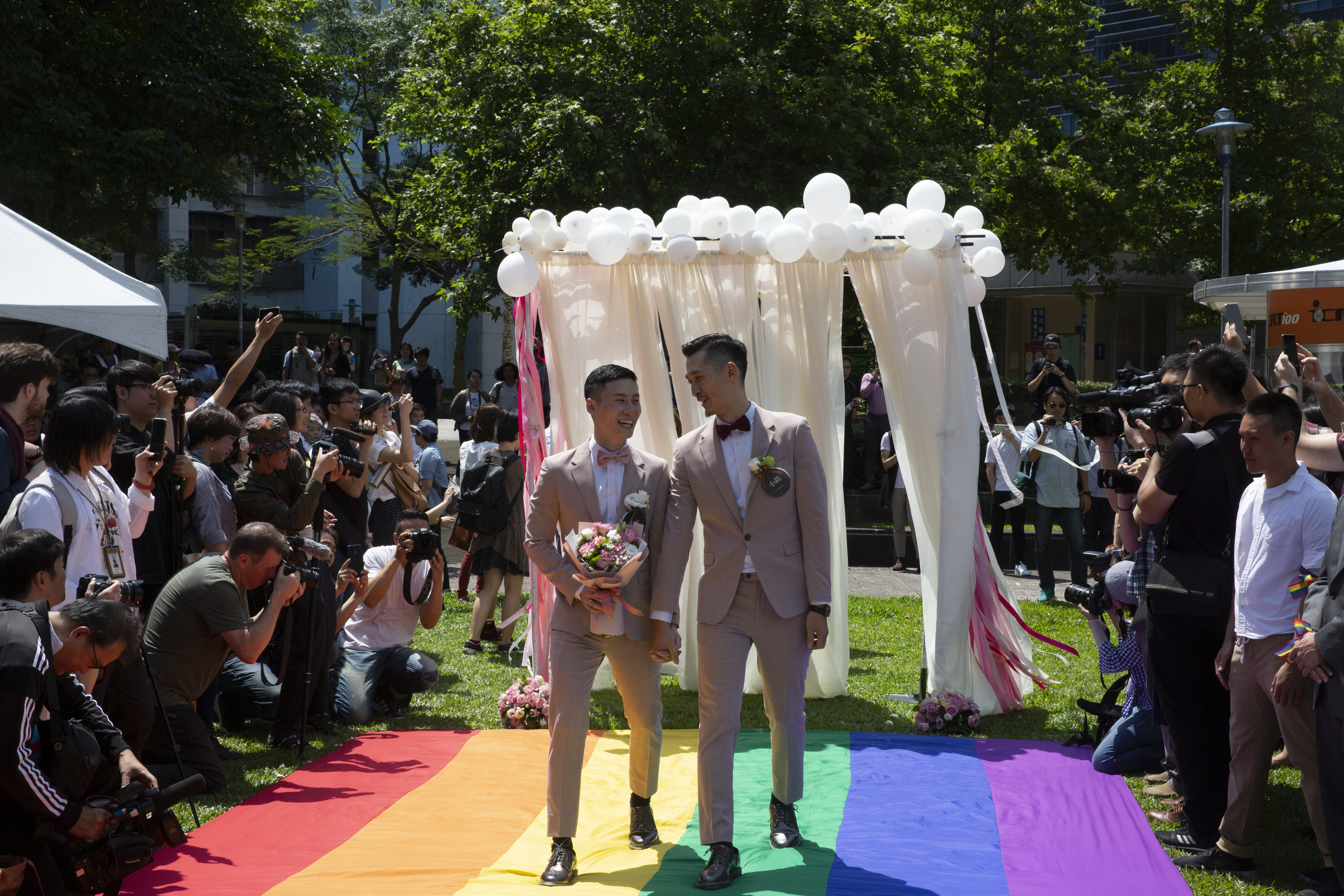 領取了結婚證書後，兩人踏上了信義廣場上鋪設的彩虹旗。