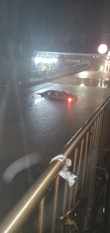 鍾男駕駛200餘萬的BMW直闖高約120公分高的積水處，造成2男女受困。（翻攝畫面）