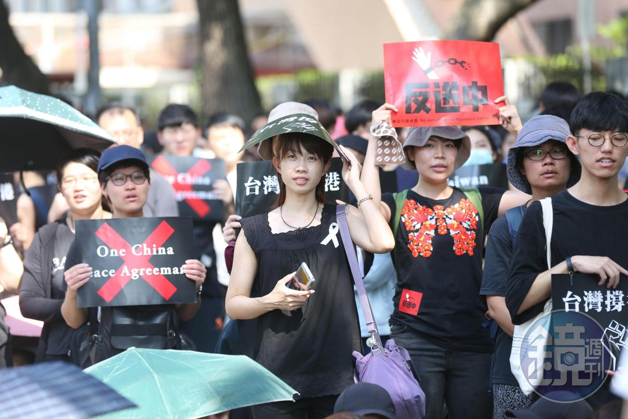 現場民眾除了身穿黑衣綁上白絲帶，紛紛舉起「台灣撐香港」「反送中」等標語。
