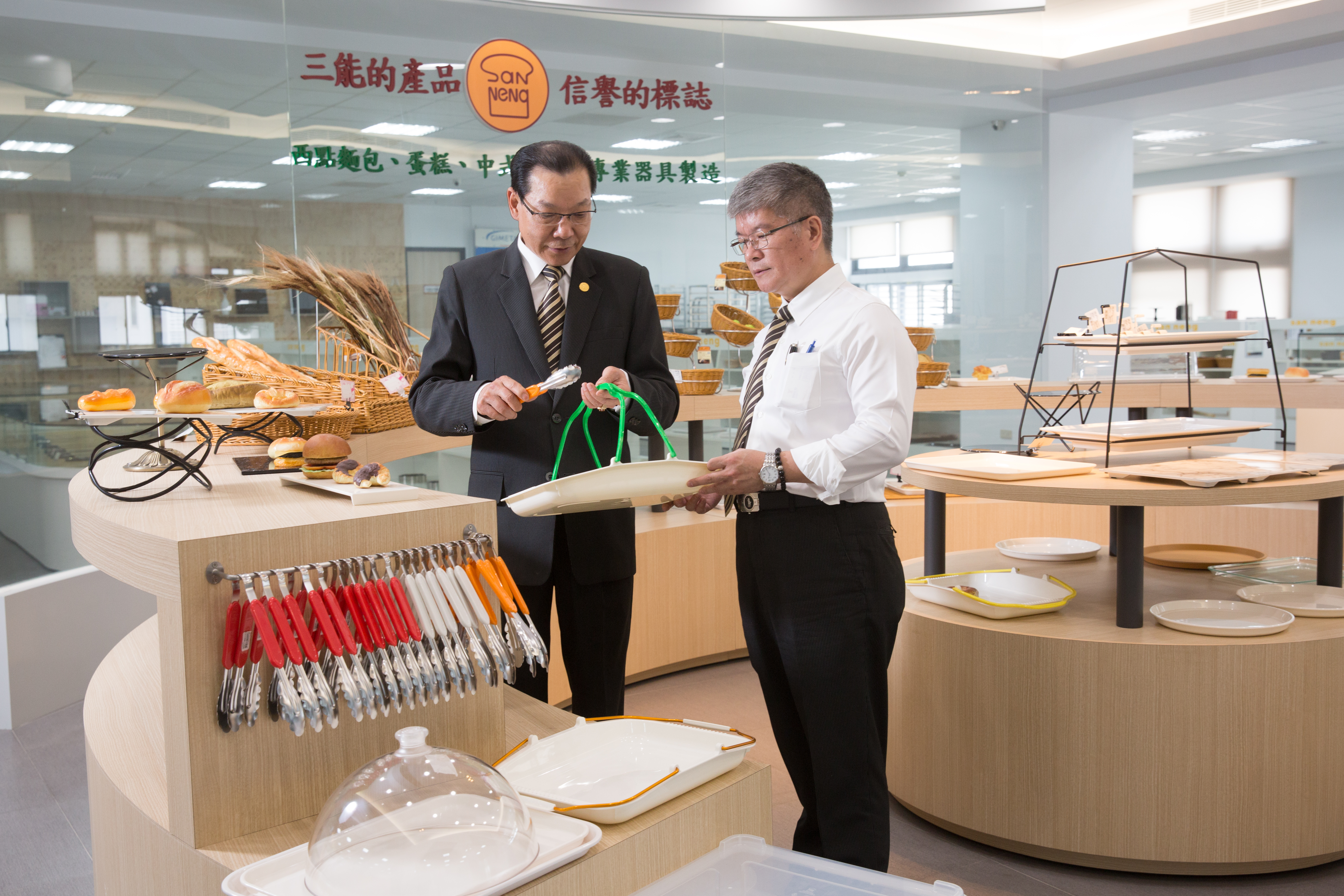 張瑞榮(左)要讓客戶可以「一站式購足」開店商品,除了烘焙器具,也開發、代理包括夾子、托盤等2000多樣產品。右為三能財務長蕭凱峰。