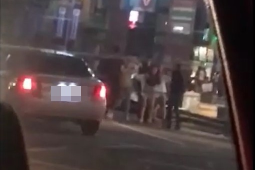 熱褲辣妹橫擋雙方人馬之間，阻止衝突發生。（翻攝畫面）