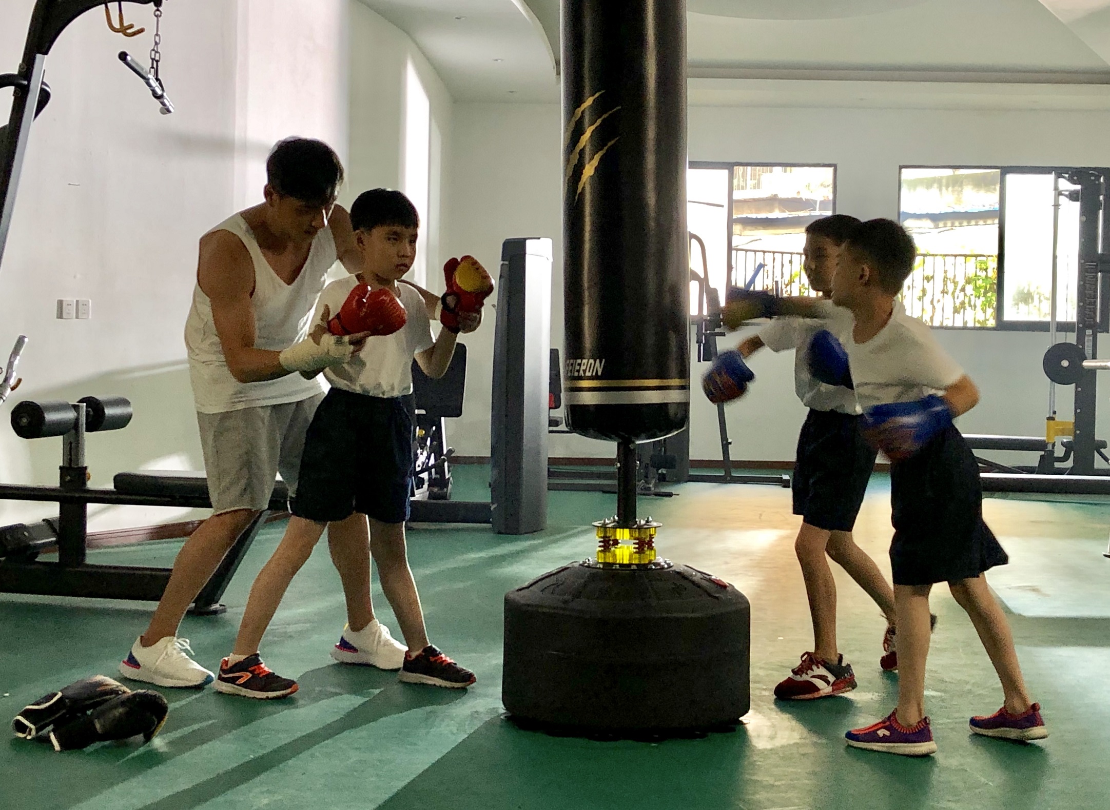 鄭人碩細心指導學童動作，幫助他們揮出人生第一拳。（海鵬提供）
