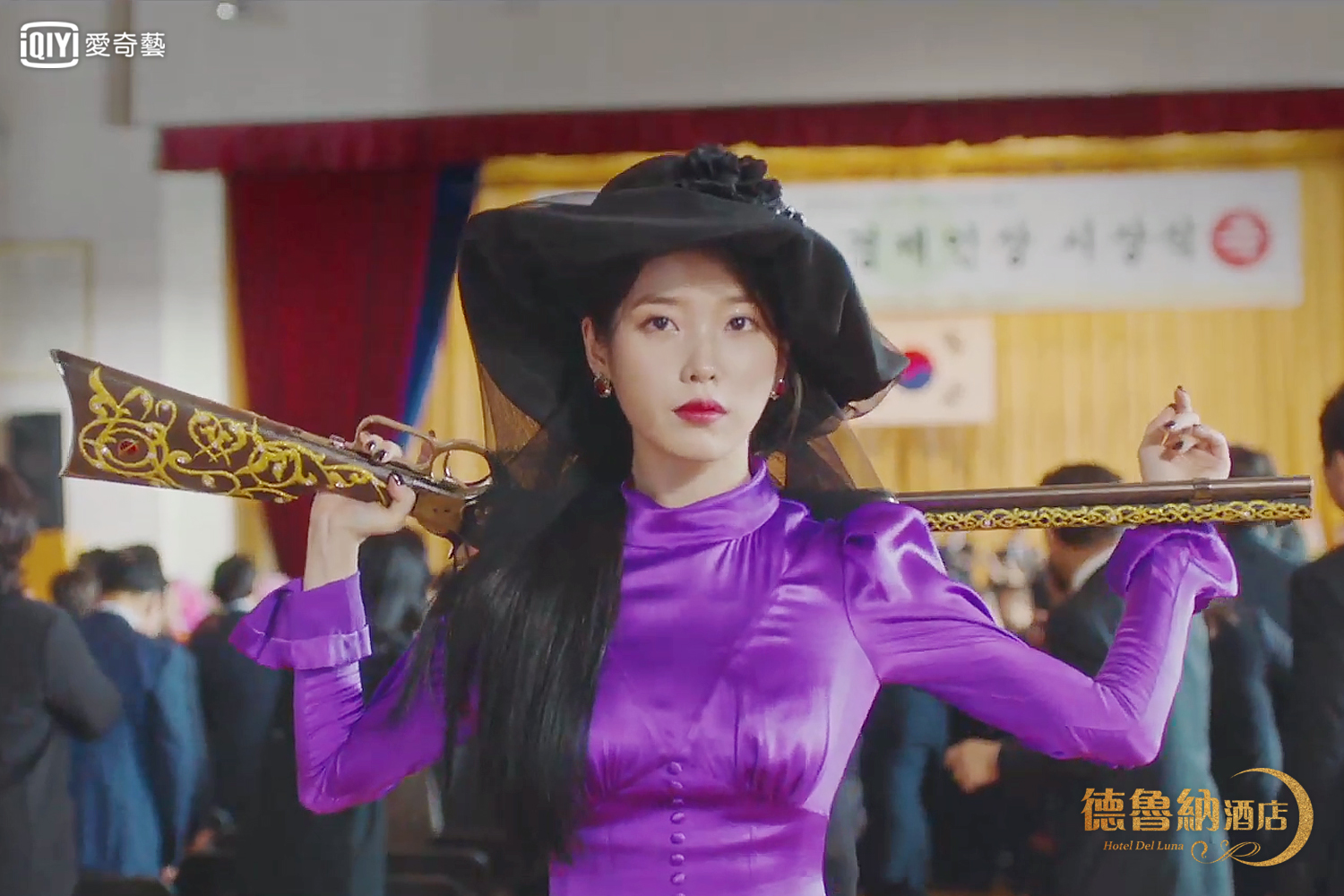 IU在《德魯納酒店》帥氣扛槍迷倒觀眾。（愛奇藝台灣站提供）