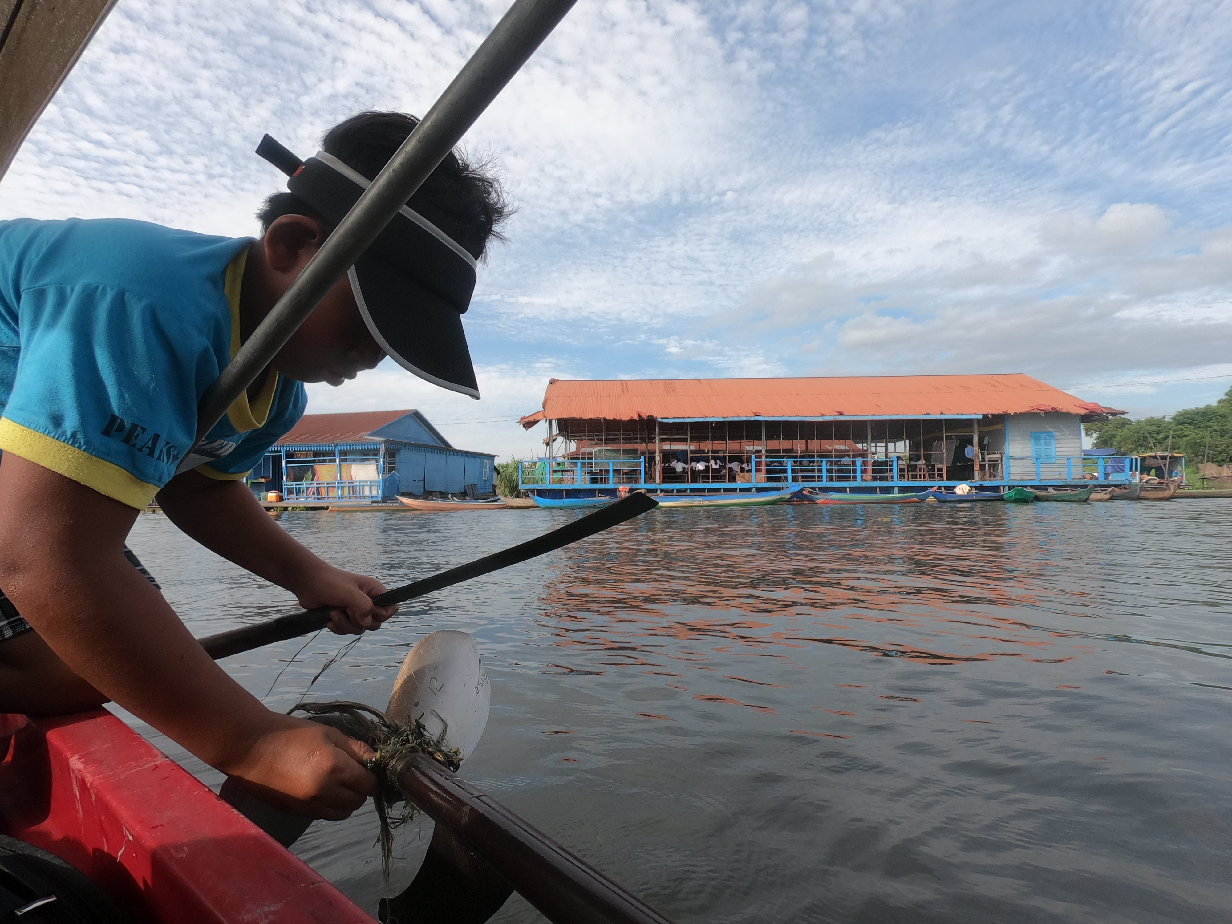 小男孩萬那地沒有去上學，這天他和爸爸的船拋錨在水上學校前，同齡孩子在上學，他在修船。