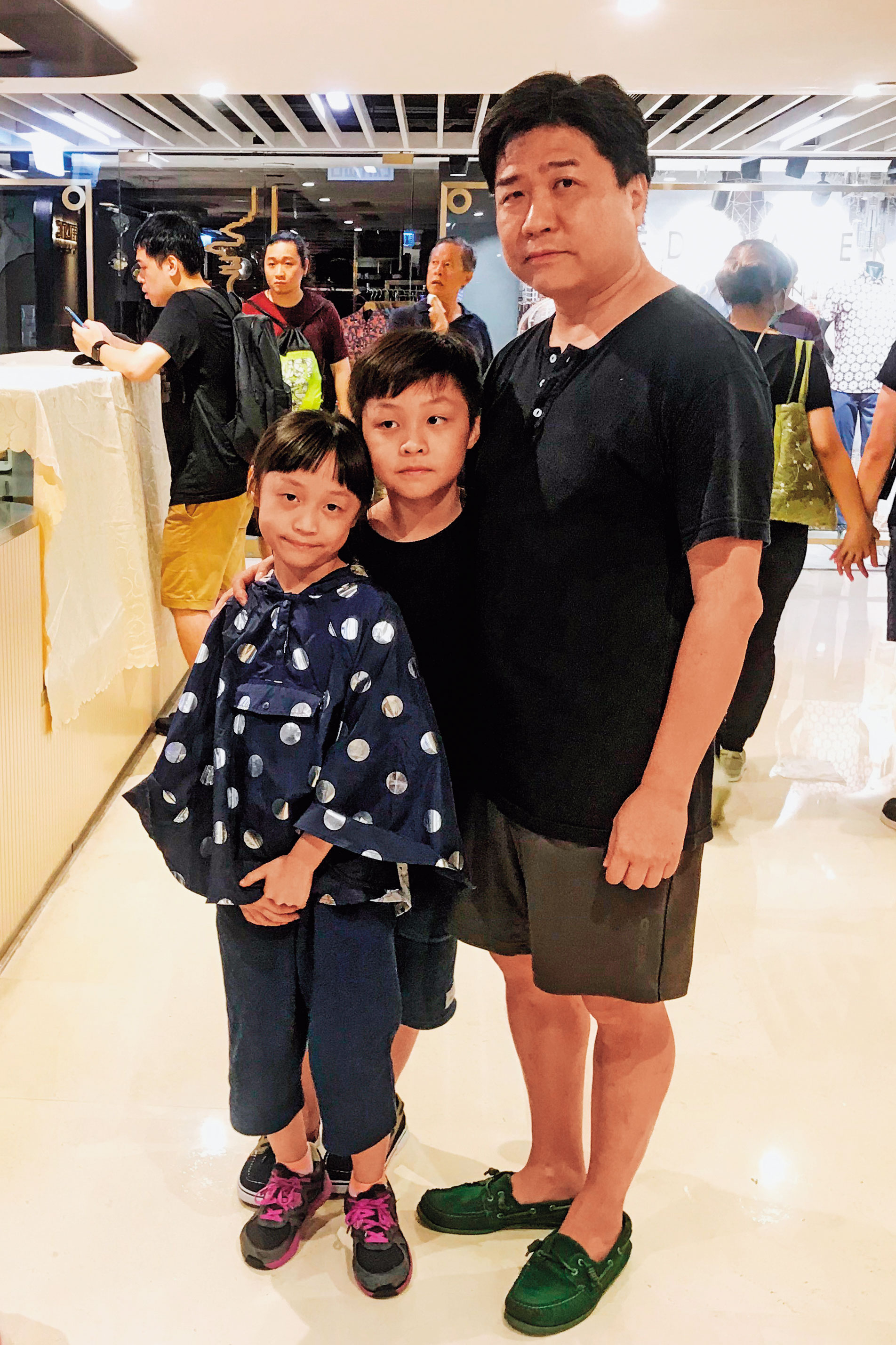 49歲的吳丹尼（化名）與參加遊行的一對兒女。