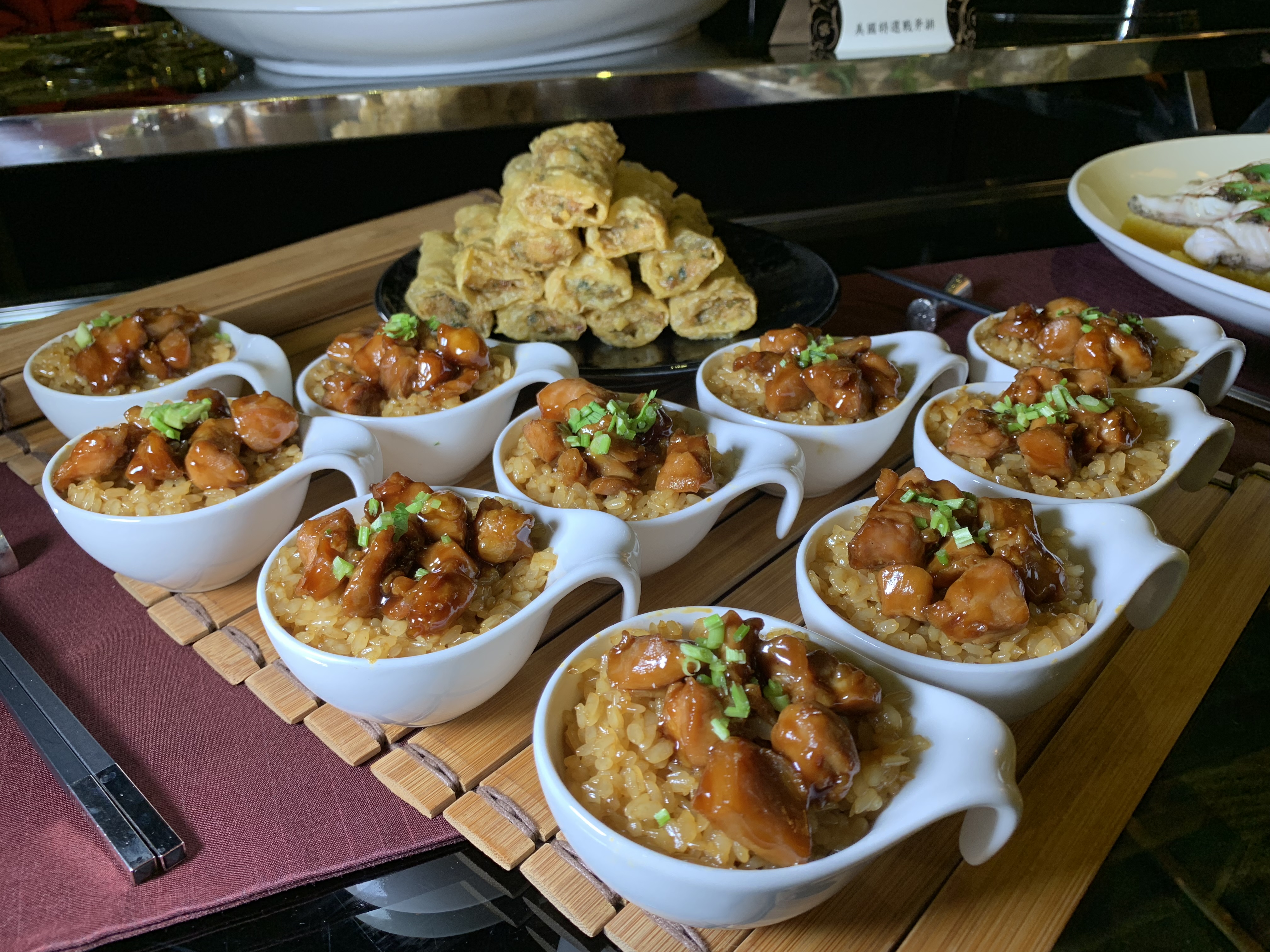 「花雕雞煲飯拼蝦捲」雞肉丁飽實入味、米飯鹹香，蝦捲外皮脆口，內餡紮實有味。