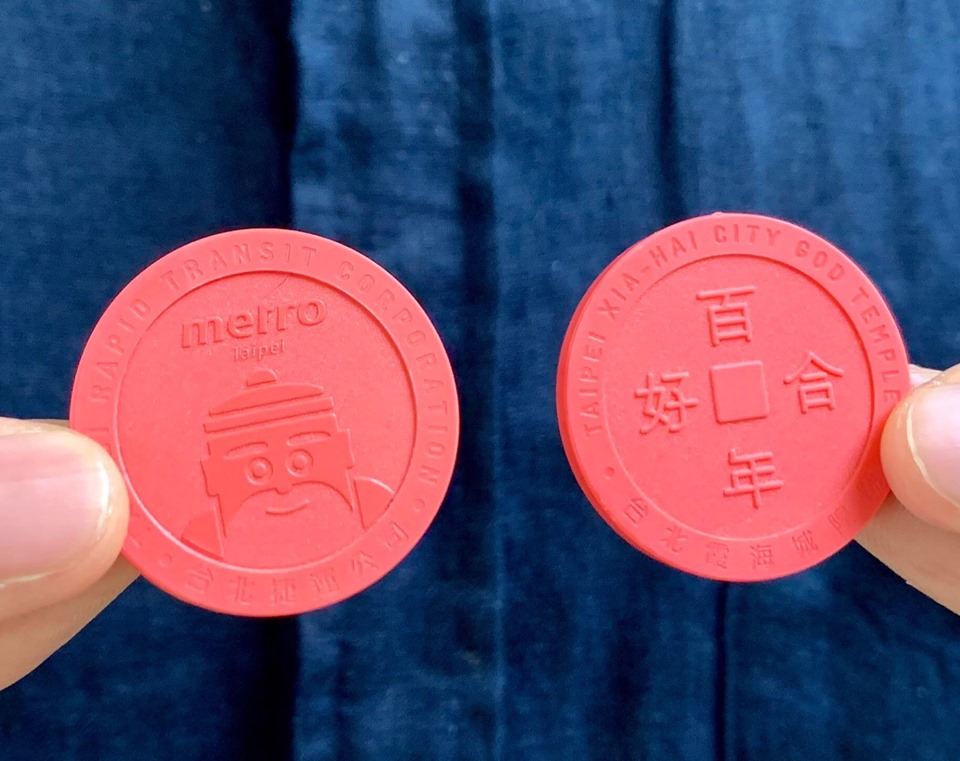 「搭紅線、捷好緣」月老車票，正面刻有「百年好合」，背面則是雙頰紅潤的月老頭像。（台北霞海城隍廟提供）