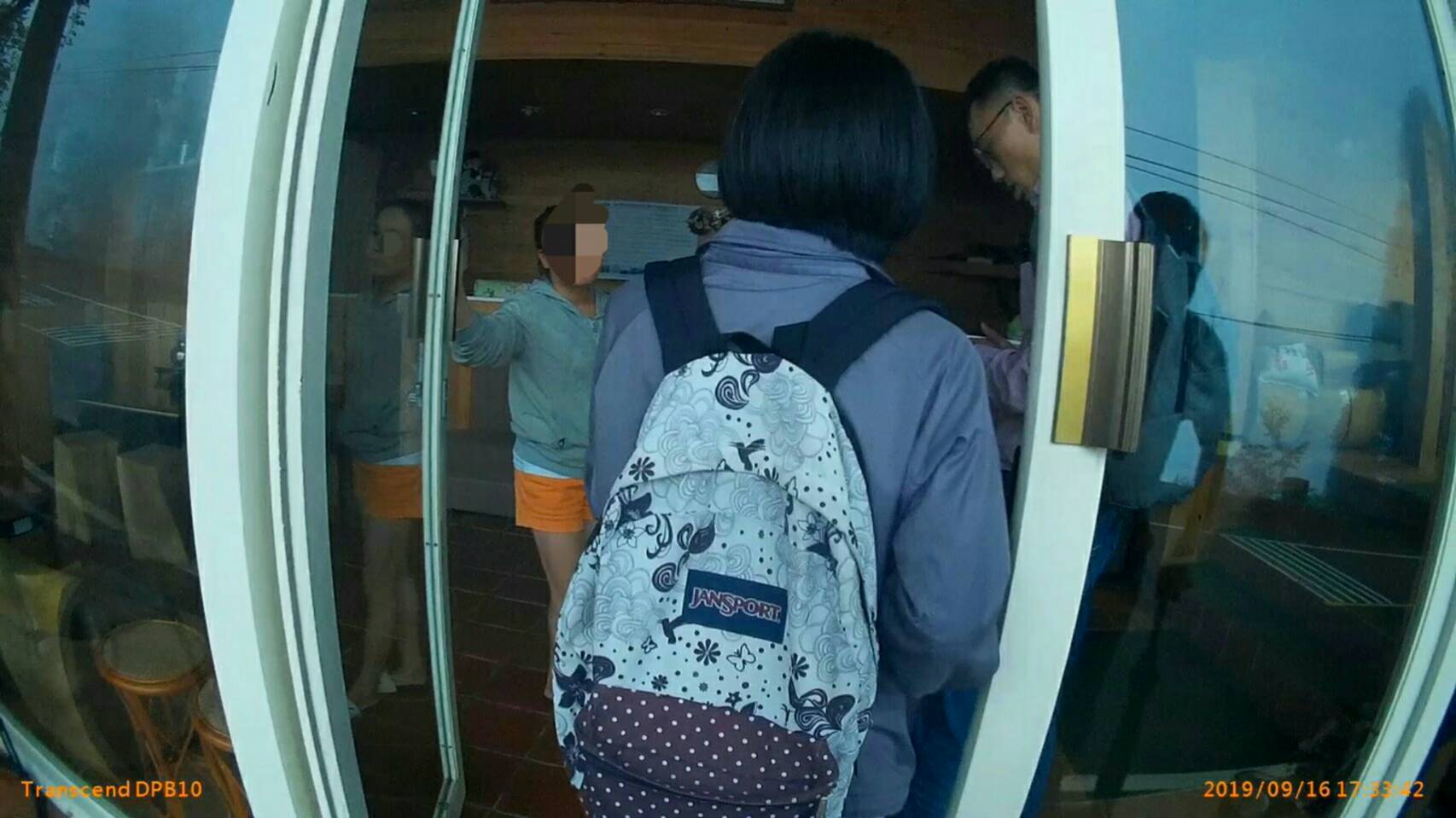 桃園市專勤隊人員喬裝旅客入住民宿，不知情的阿桃開門迎接。（翻攝畫面）
