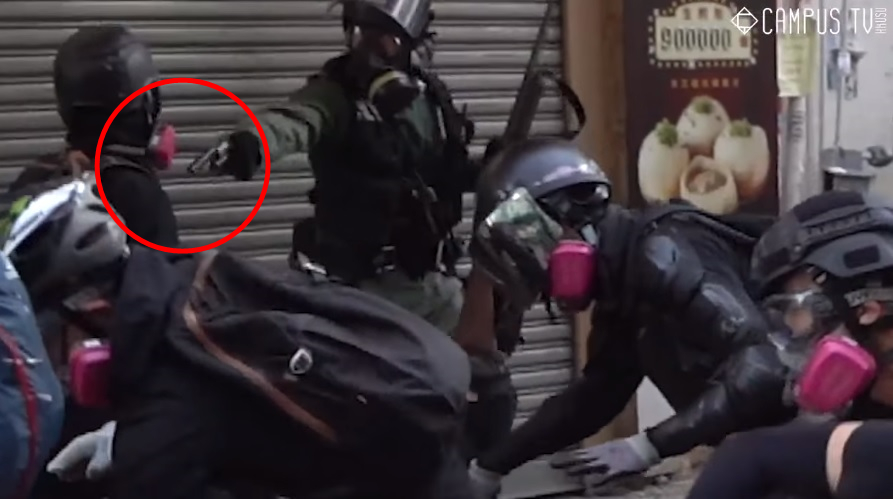 一名示威者遭警方近距離射擊左胸（紅圈處），中槍倒地後，被送往瑪嘉烈醫院急救中。（翻攝自香港大學學生會校園電視）