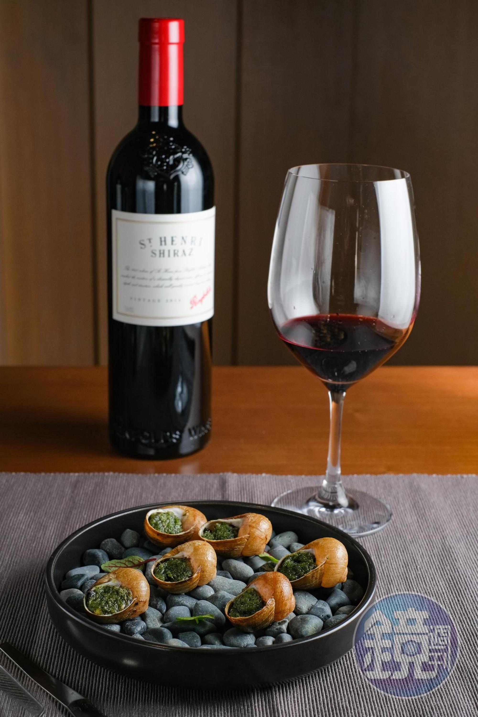 「ST. Henri Shiraz 2016聖亨利 希哈紅葡萄酒」的酸度，可平衡香料奶油焗烤田螺的濃重。（台中限定酒單供應2014年份，980元／杯、4,900元／瓶）