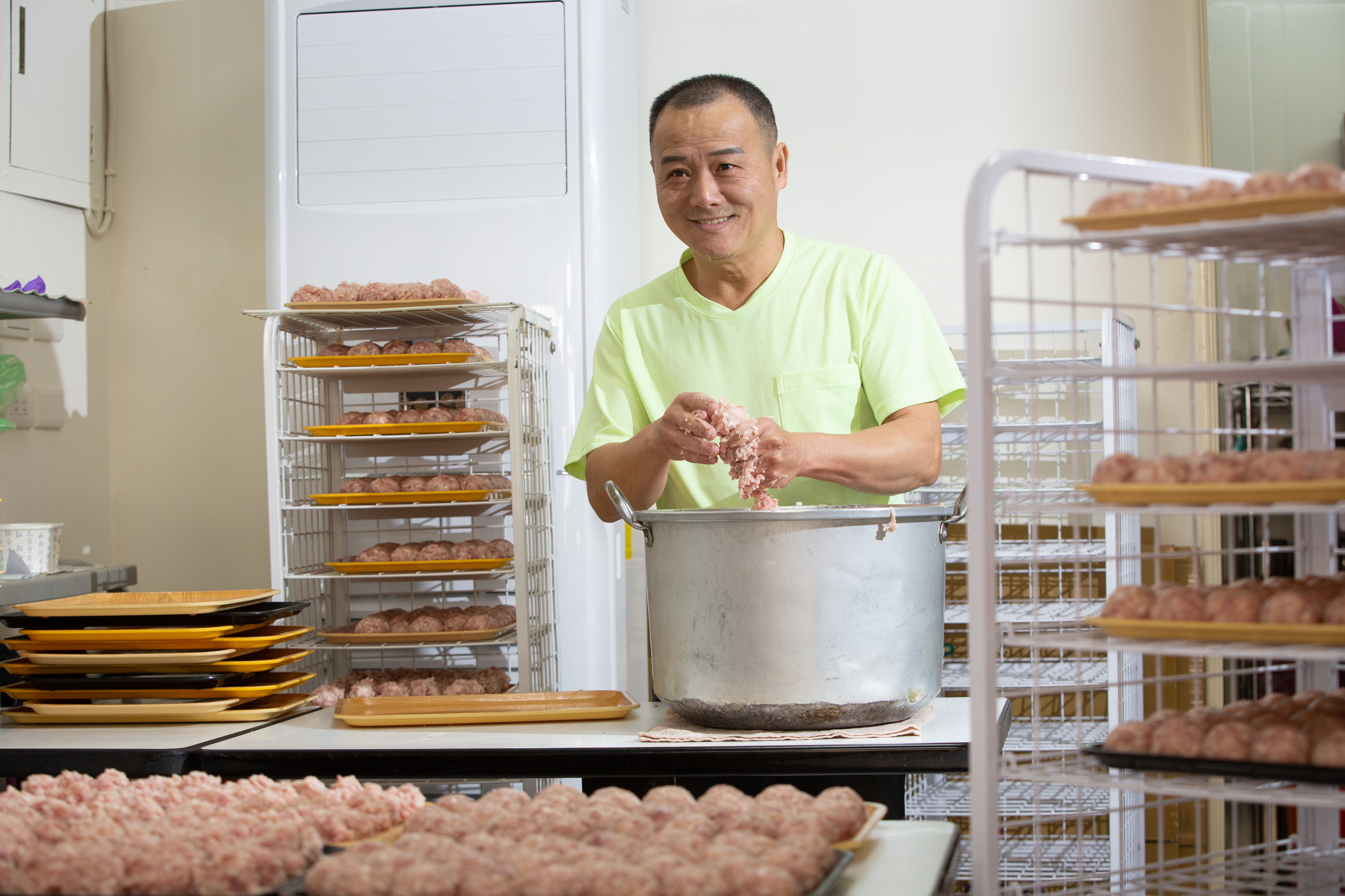 製作獅子頭相當費工，馮坤志以1秒1顆速度從虎口擠出肉丸，再搓圓塑形。