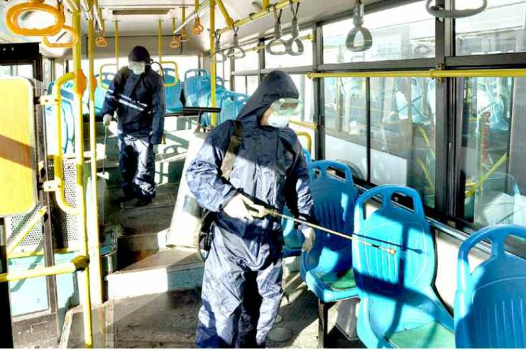 北韓的衛生人員在新義州的公車上進行消毒。（網路截圖：Rodong Sinmun）