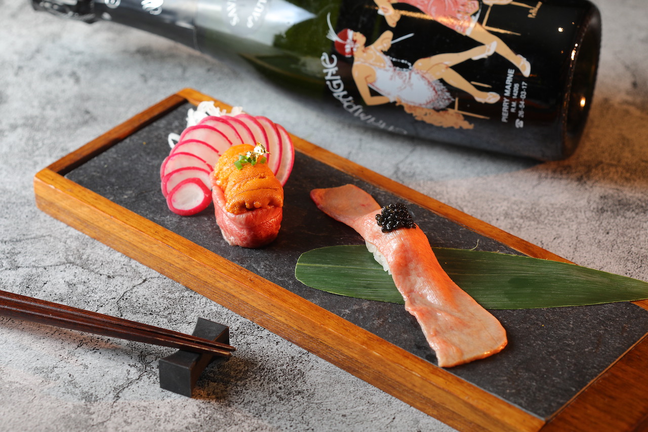 壽司「和牛海膽軍艦」的和牛板腱肉脂香滑潤（左，380元／份）、「牛舌握魚子醬」甘鹹（右，320元／份），選搭帶果乾、蜜餞香氣的「Guy Michel Paris Folies Saveur 1988」（5,800元／瓶）富層次的風味。