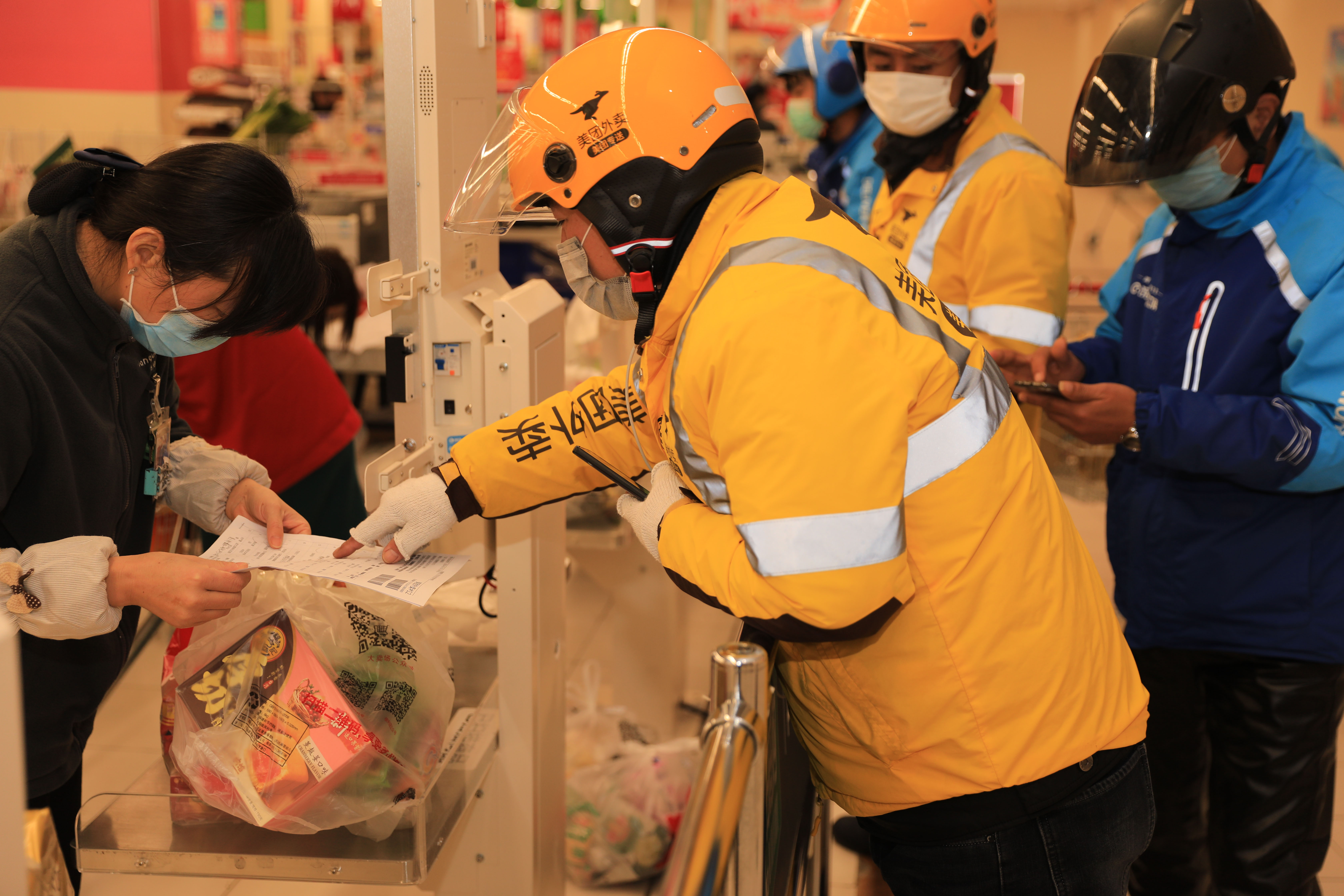 疫情當頭，許多中國市民選擇足不出門，線上採買，圖為舟山某超市外送員領取超市配送訂單。（東方IC）