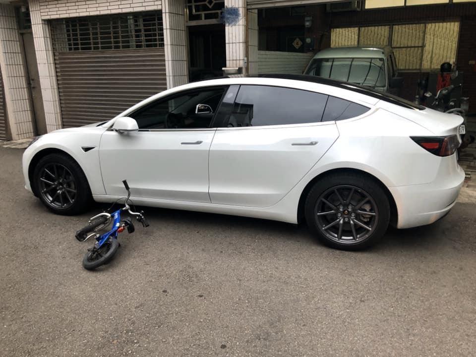 嶄新特斯拉轎車遭孩童腳踏車撞上，車身些微受損。（翻攝臉書）