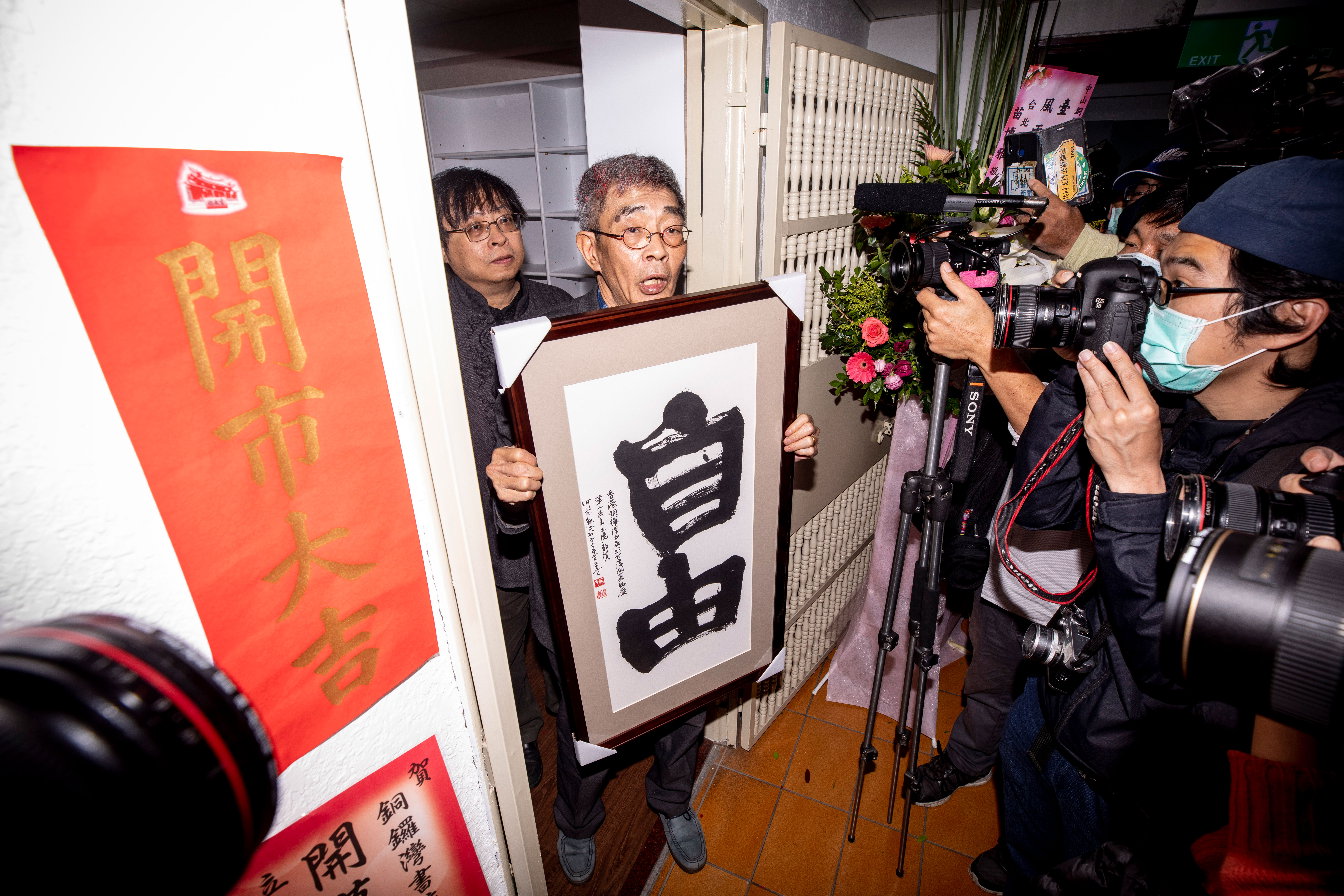 今年4月25日，銅鑼灣書店在台灣如期開幕，花籃和祝福湧入小店。圖為林榮基捧著華人民主書院致贈的「自由」牌匾。