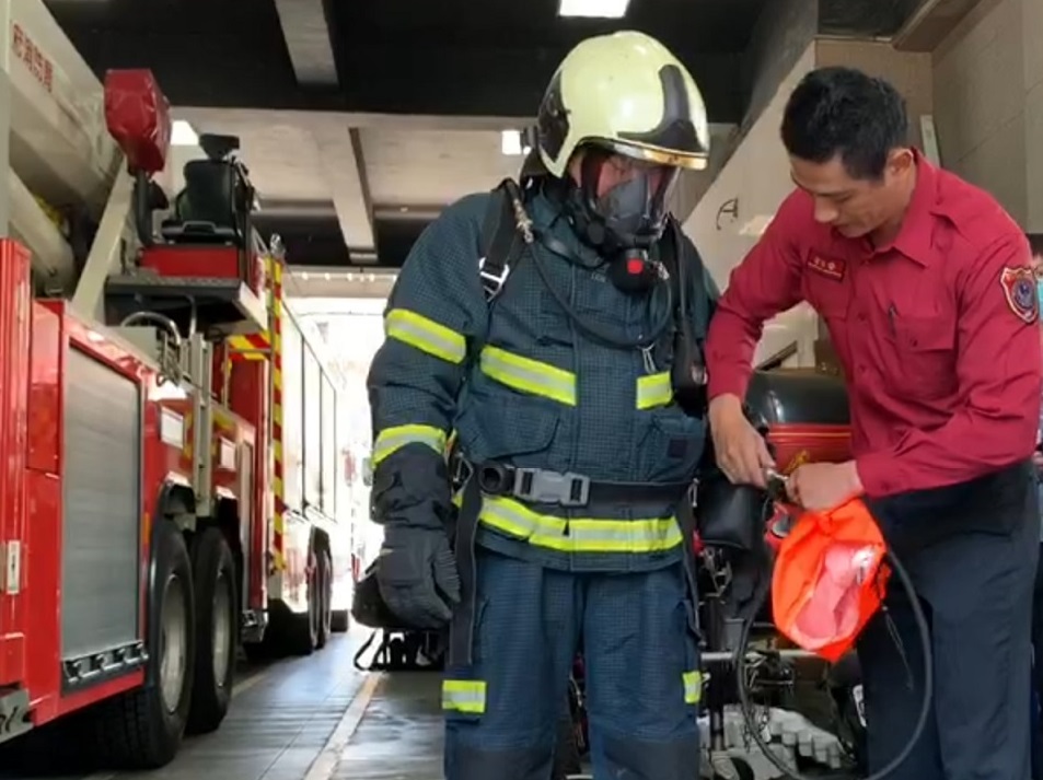 警消解釋在火場內共生面罩的使用方式。（翻攝畫面）