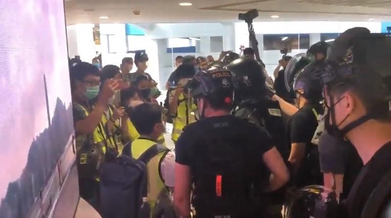 防暴警察包圍13歲學生記者,質疑其記者身分。(翻攝自香港眾志推特)