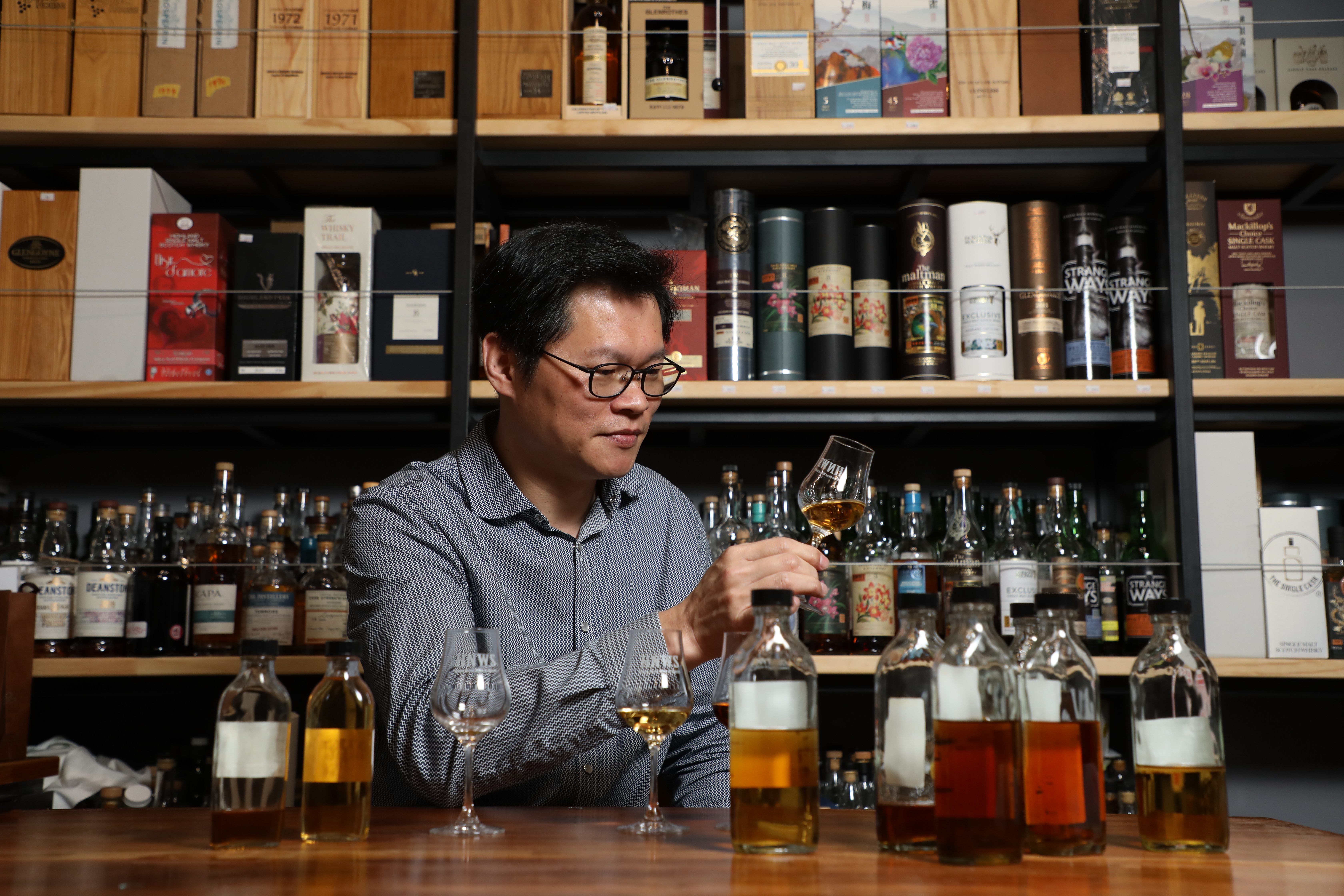 平日說話有些木訥，講起酒便滔滔不絕的邱春龍，很擅長在樣品堆中挖寶，是台灣酒類專賣店中的選桶達人。