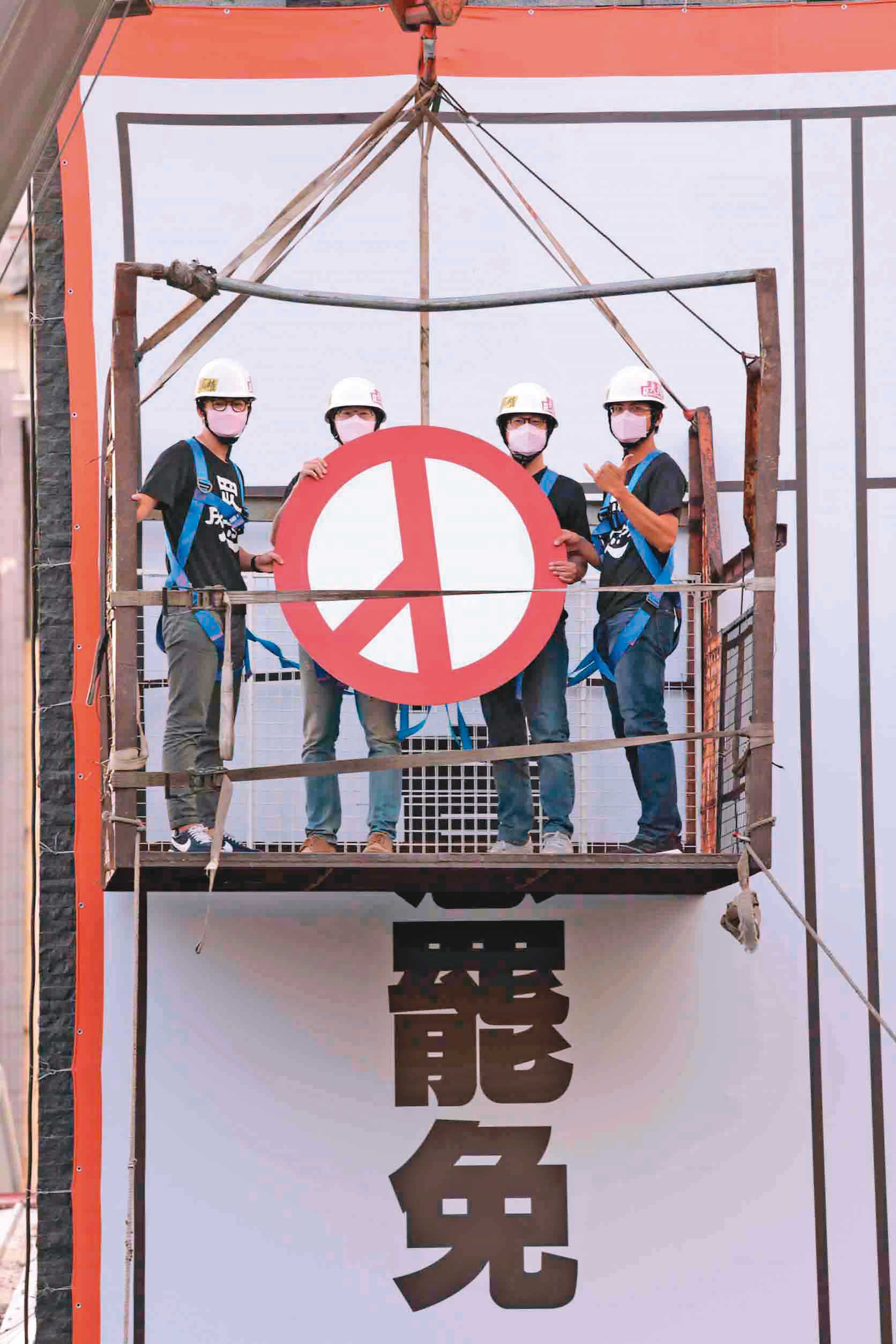 目前各項民調顯示，超過半數高雄市民支持罷韓。圖為罷韓四君子4月17日在罷韓總部外搭乘吊籠，將投票標記貼在同意票欄位上。（光復高雄總部提供）