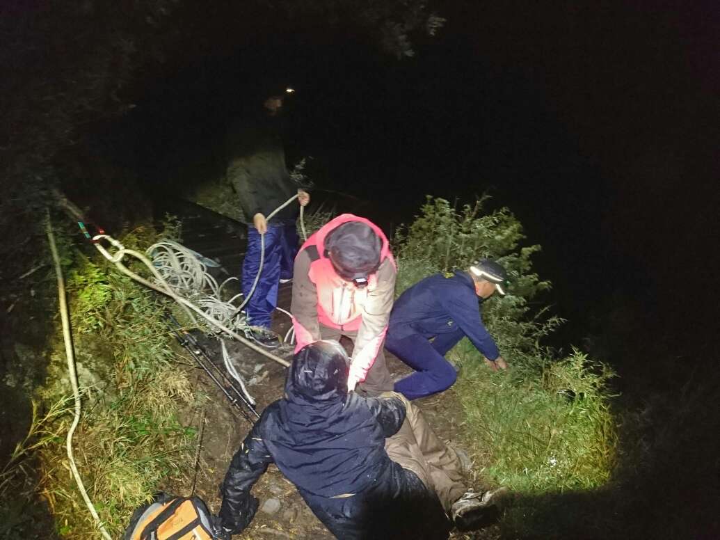 山友單日往返玉山主峰摸黑回程墜崖掉落邊坡，玉山處人員抵達現場架設繩索，成功將墜崖山友拉回步道。（玉管處提供）