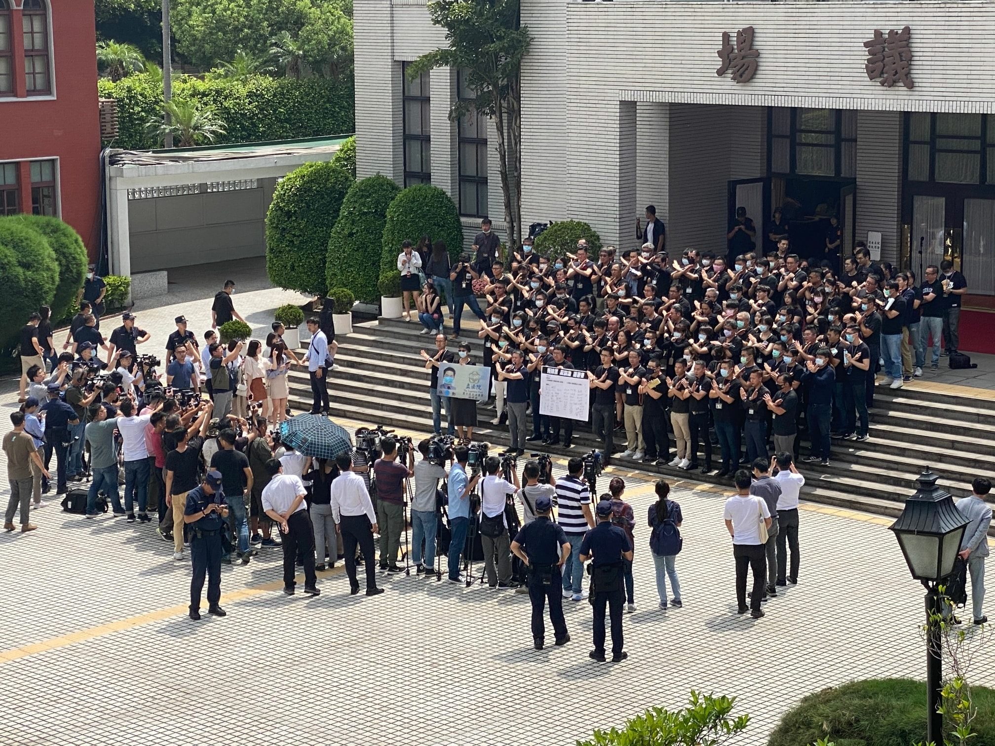 國民黨立院黨團為了抗議被抹「黑」，找來助理穿黑衣圍議場抗議。 （翻攝自陳柏惟臉書）