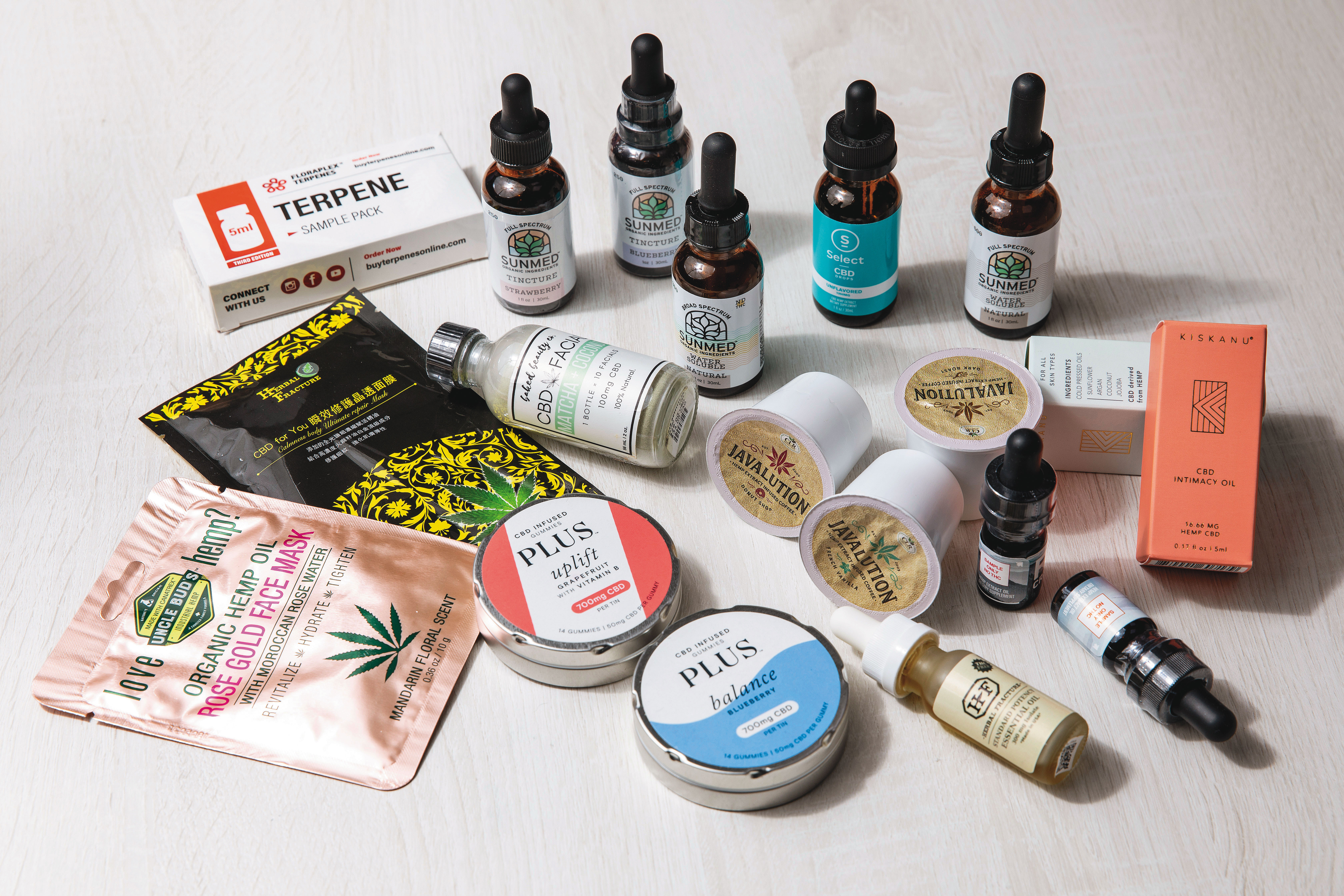 李菁琪律師攤開一堆從國外購買的CBD商品，有的加在軟糖、有的做成面膜，產品相當多元。