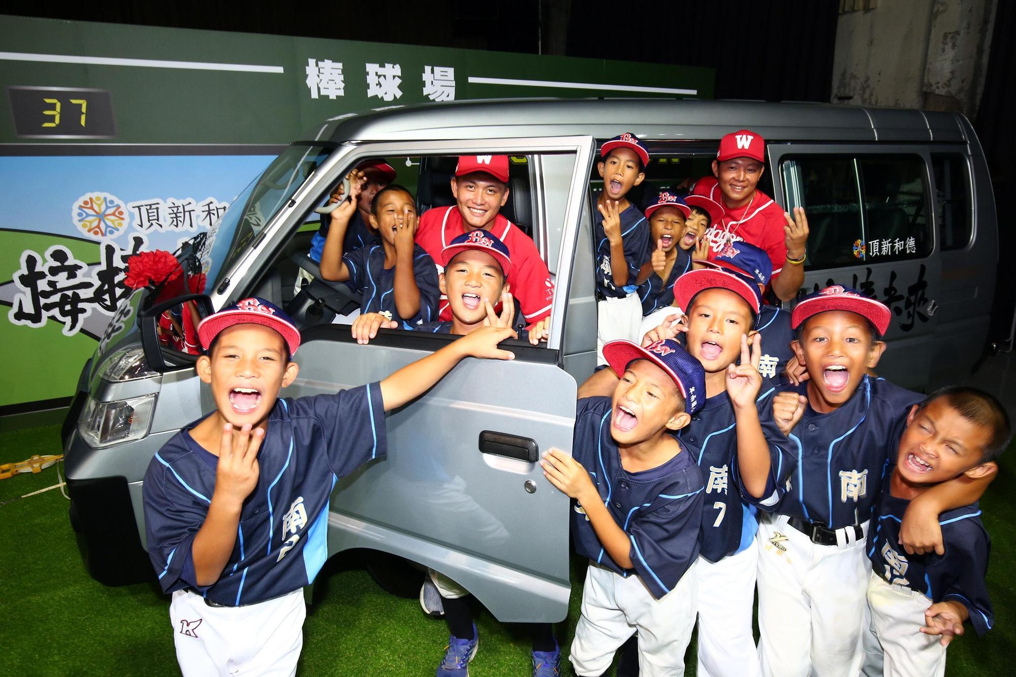 卑南國小少棒隊與味全龍隊選手劉基鴻(左)、黃柏豪(右)。(頂新和德文教基金會提供)