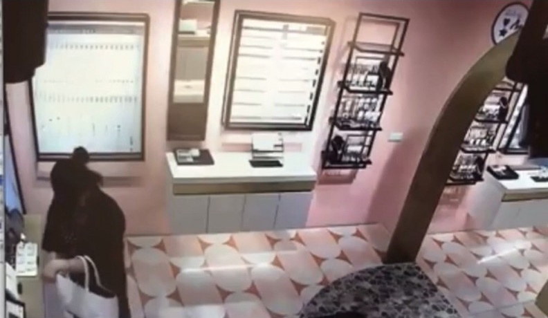 爆乳女趁店家未注意之際，迅速將手中飾品塞到提袋內，手法相當老練。（翻攝自爆料公社臉書社團）