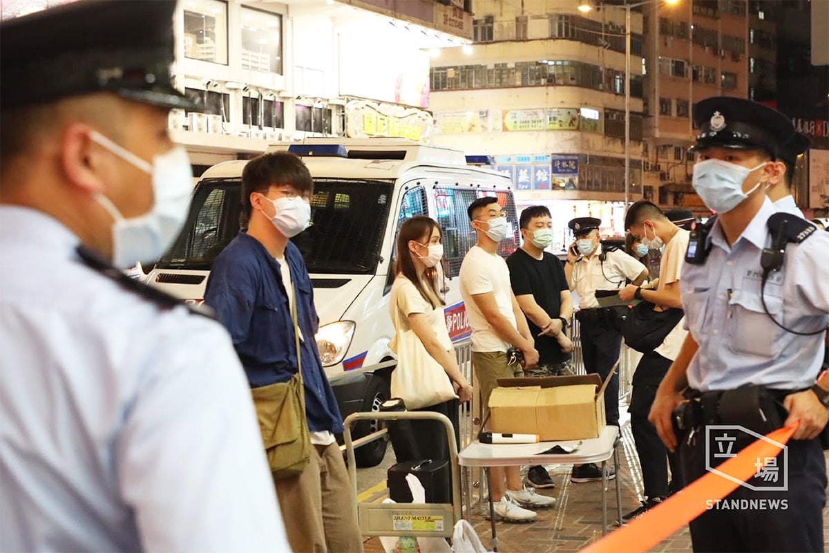 前香港眾志成員周庭在街頭反對「健康碼」宣傳攤位上被港警包圍，並以違反限聚令對他們開罰。（翻攝周庭臉書）