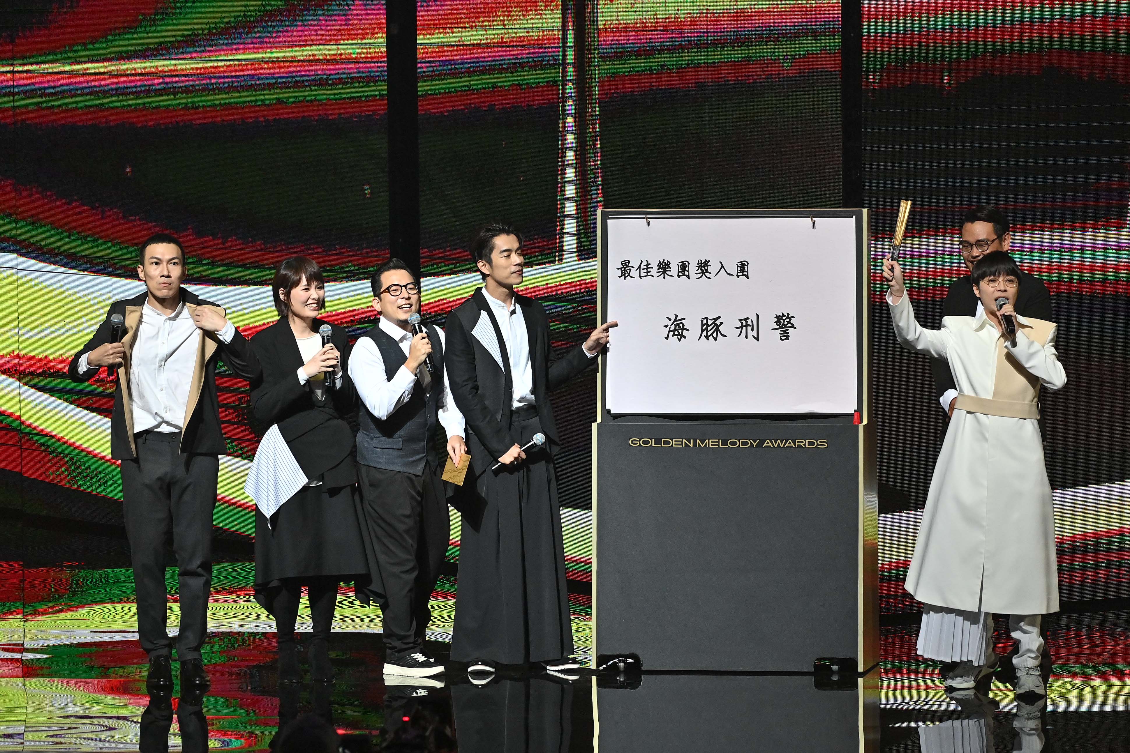 「魚丁糸」擔任首組頒獎人，六人準備大字報，以測字方式分析入圍樂團的得獎機會，但氣氛頗為冷場。（台視）