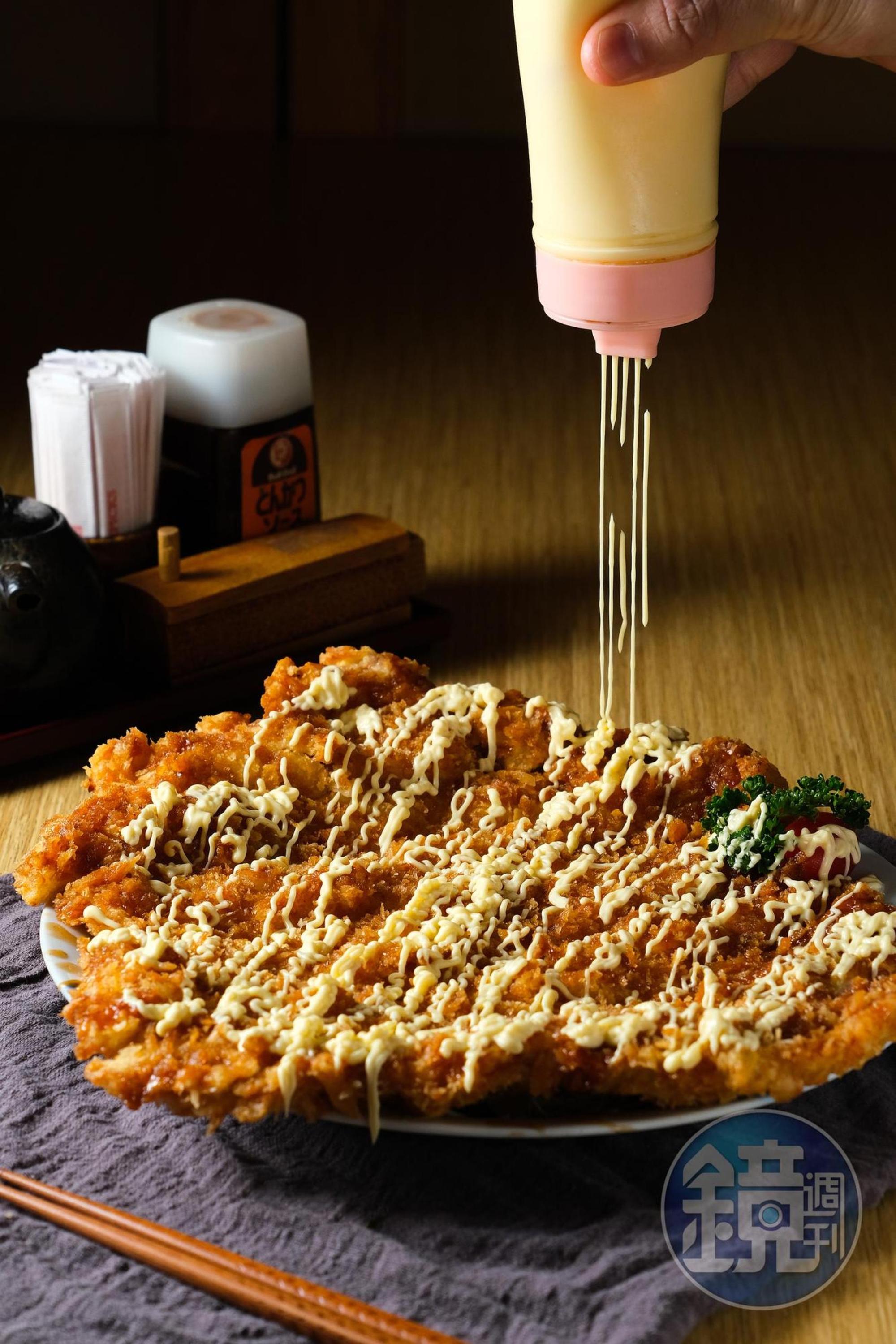 比盤子大的「草鞋豬排」用粗挽麵包粉,表面積雖大卻酥香不油膩。(450元/份)