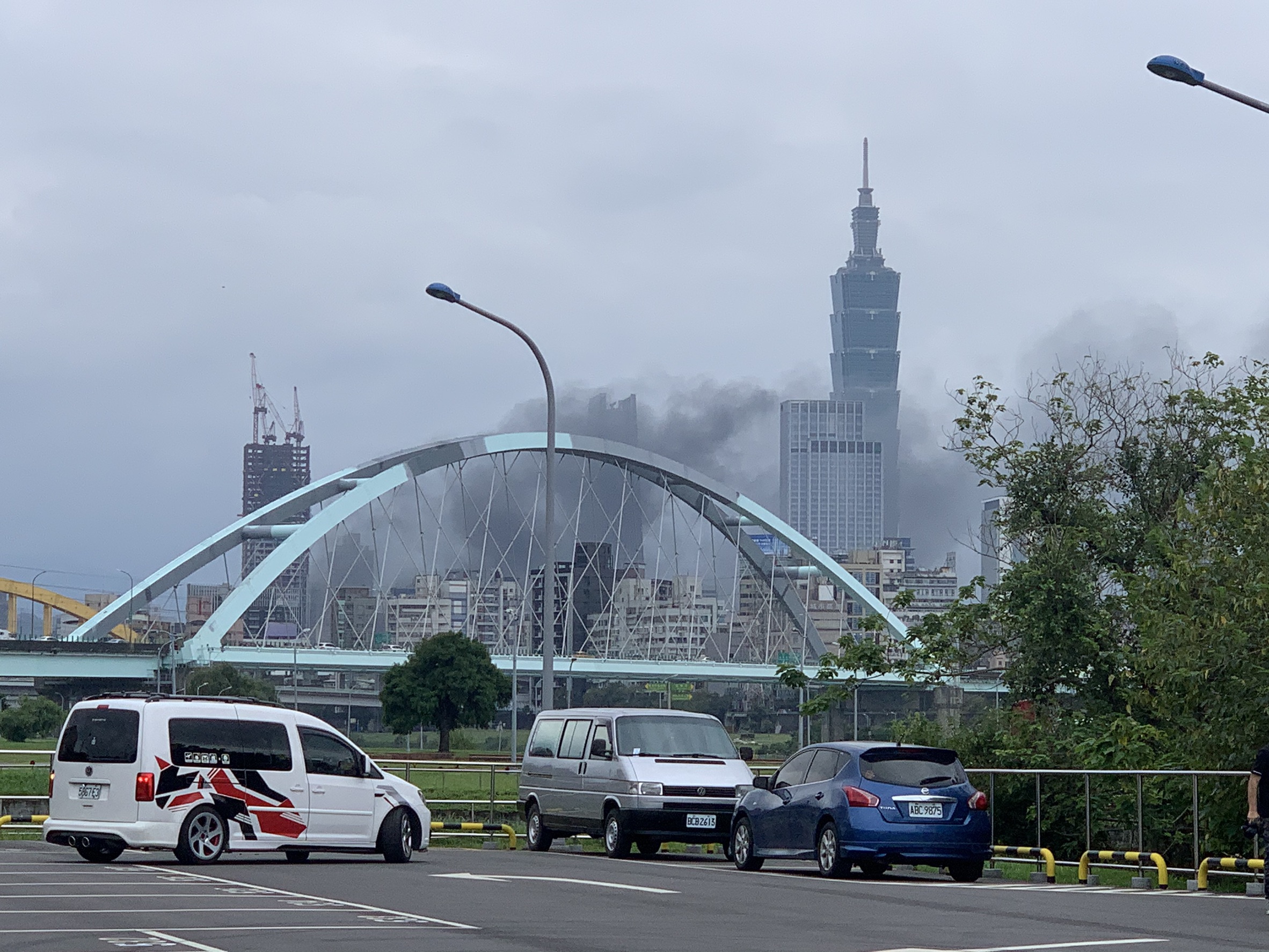 台北市信義區下午發生機車大火，濃煙竄升連鄰近區域都看得到。（翻攝畫面）