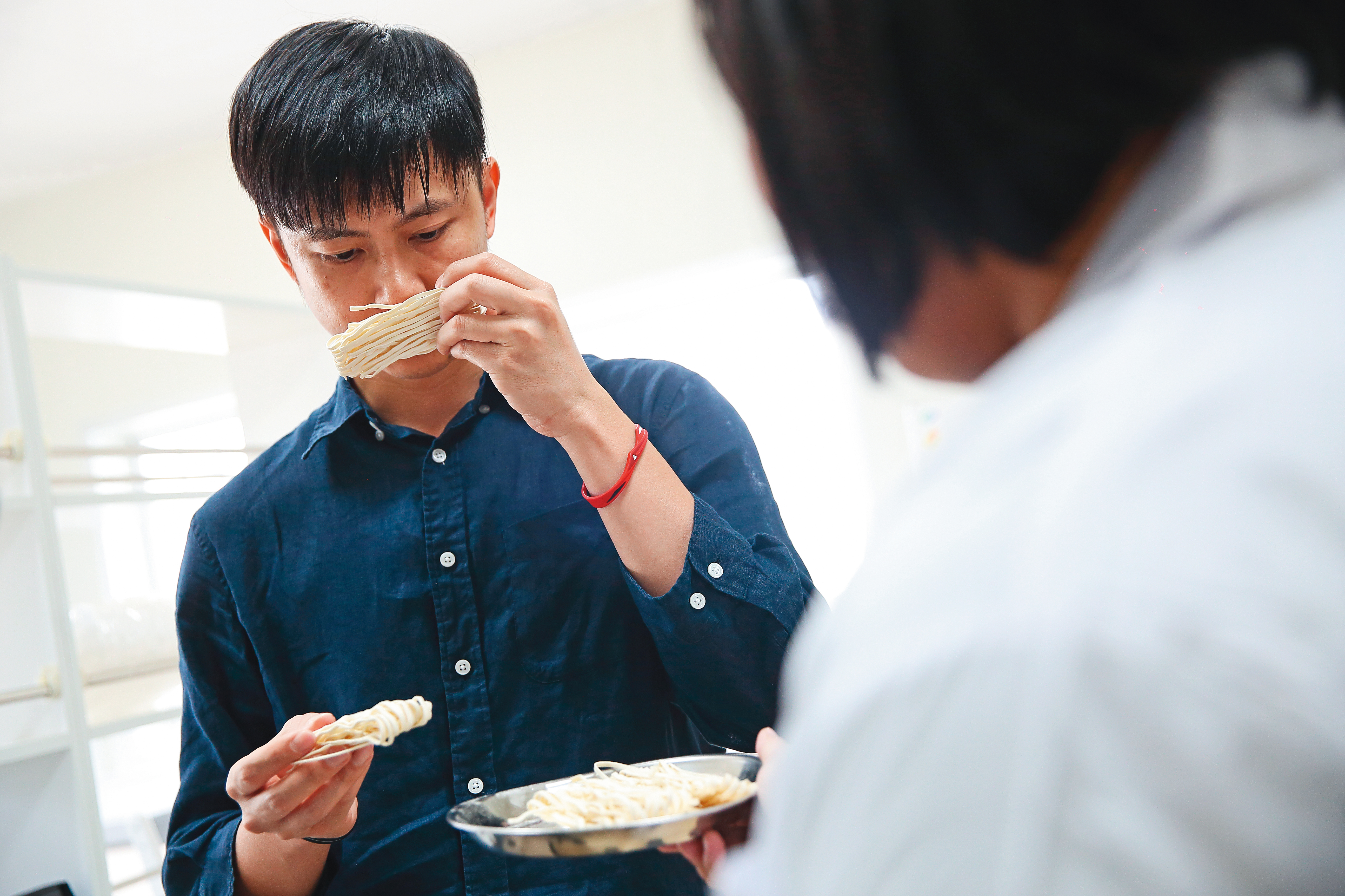 吳光林(左)在自家廠房成立食品安全檢驗室,抽檢產品的含水量和生菌數是否合格。