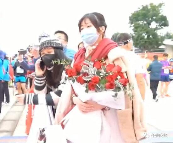 女子身穿婚紗在馬拉松終點處等參賽男友,準備給他求婚驚喜。(翻攝自微博)