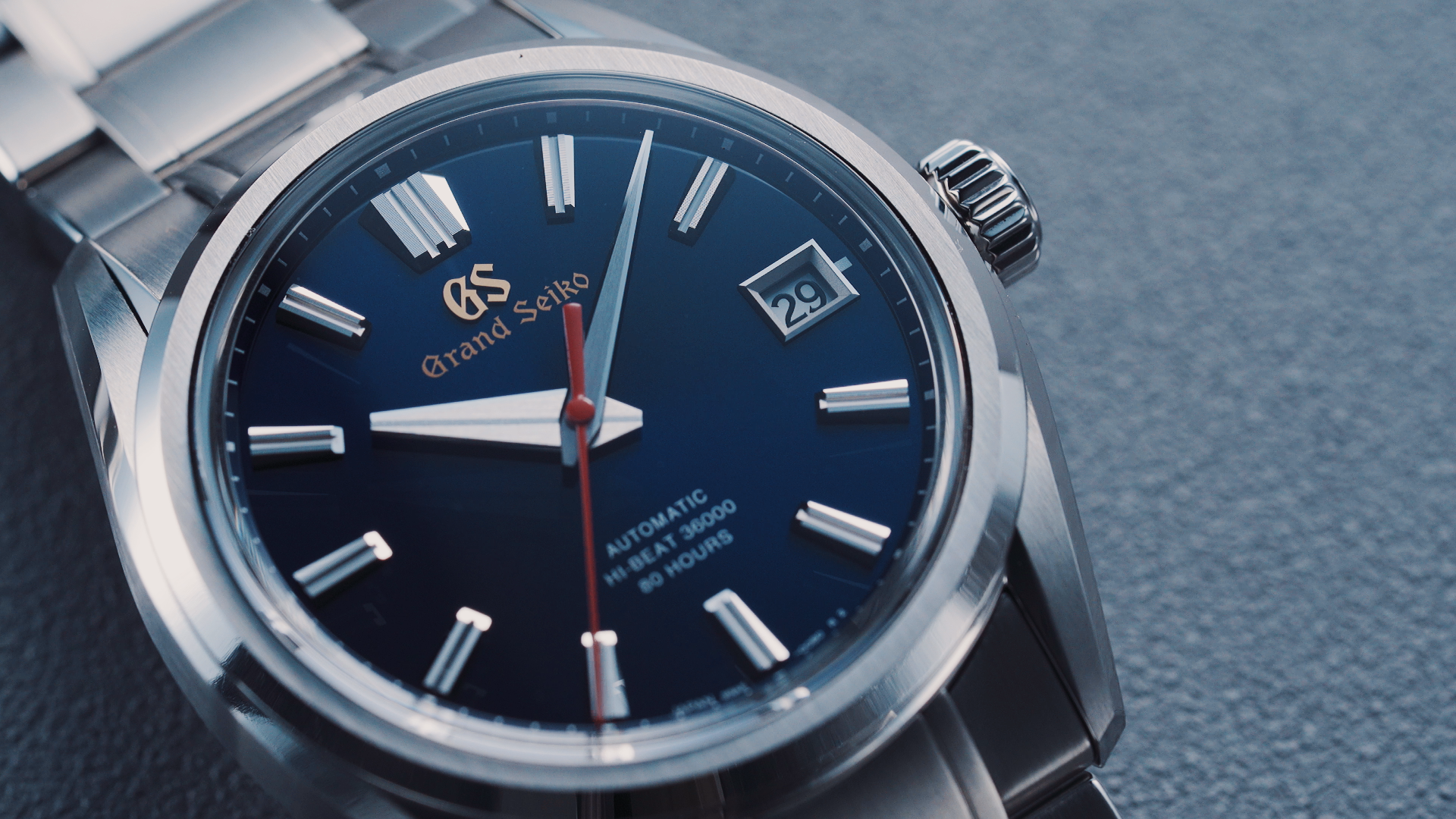 這款精鋼版本的Grand Seiko SLGH003，定價比起SLGH002大幅降低，只要約NT$305,000。是目前市場上最入門的衝擊式擒縱機芯錶款。