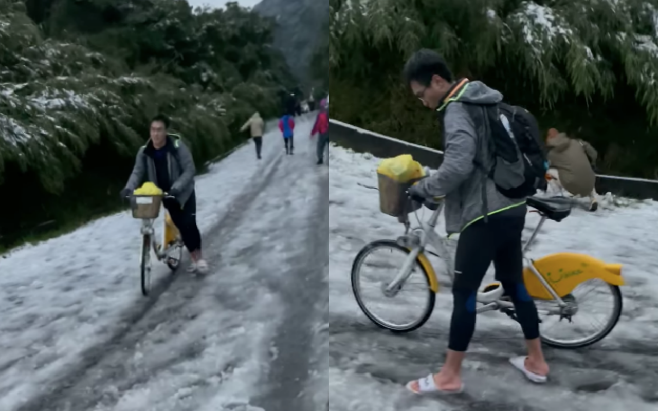 一名男子昨天騎著YouBike只穿著拖鞋,就衝陽明山二子坪賞雪,結果地面結冰寸步難行。(翻攝臉書社團「●【爆廢公社公開版】●」,影片由網友 Nick Yang 拍攝)