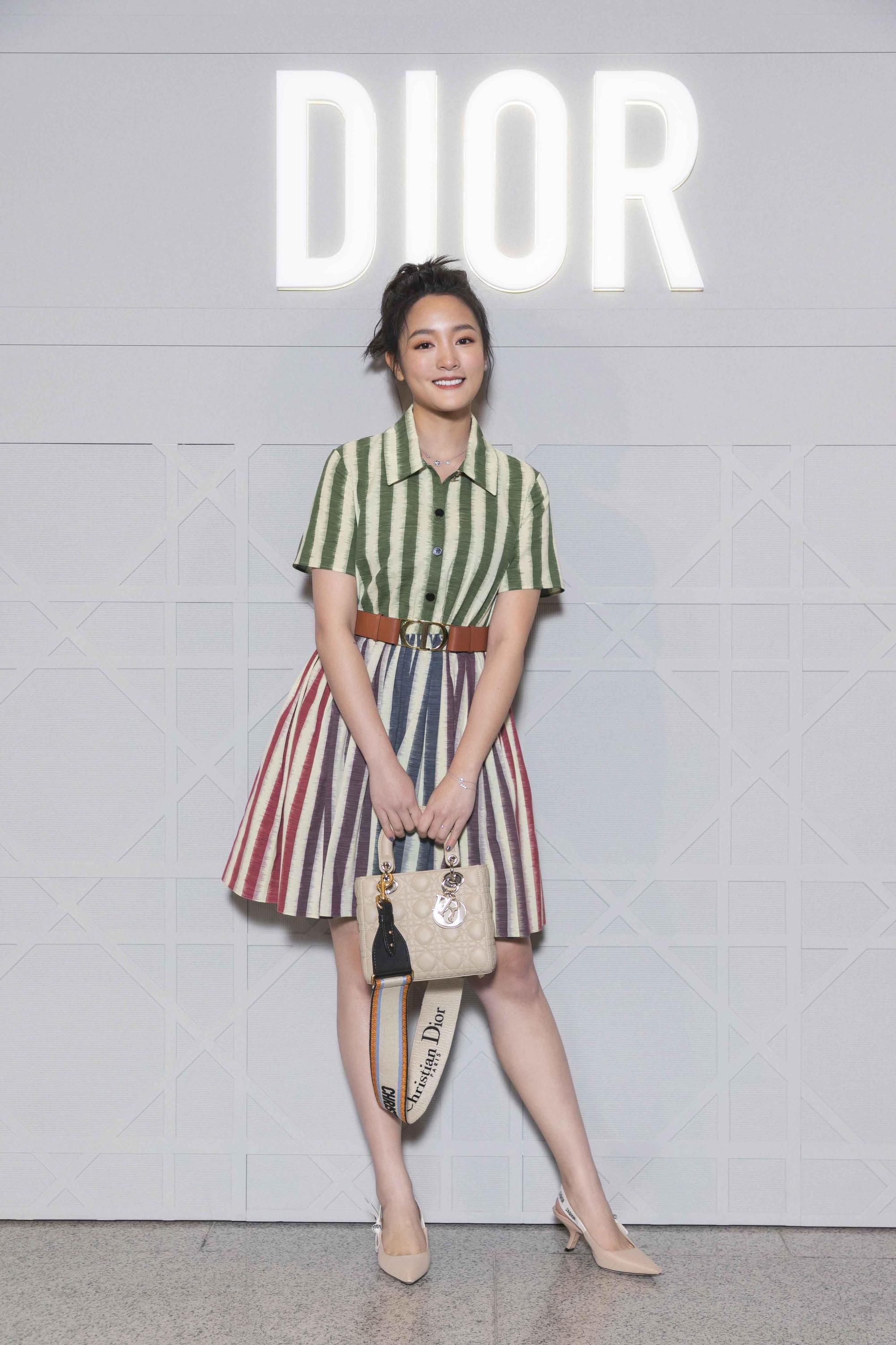 王淨彩色條紋棉織洋裝價格店洽、米色襯褲NT$34,000、30 Montaigne橘褐色光滑小牛皮腰帶NT$29,000、My ABCDior米色小羊皮提包搭配琺瑯彩繪吊飾NT$145,000、米色刺繡帆布寬背帶NT$34,000。（迪奧提供）