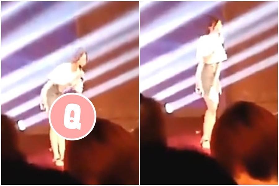 大陸一名正妹在台上演講,窄裙內突然滑出不明物體,引發網友關注。(翻攝自虎撲討論區)