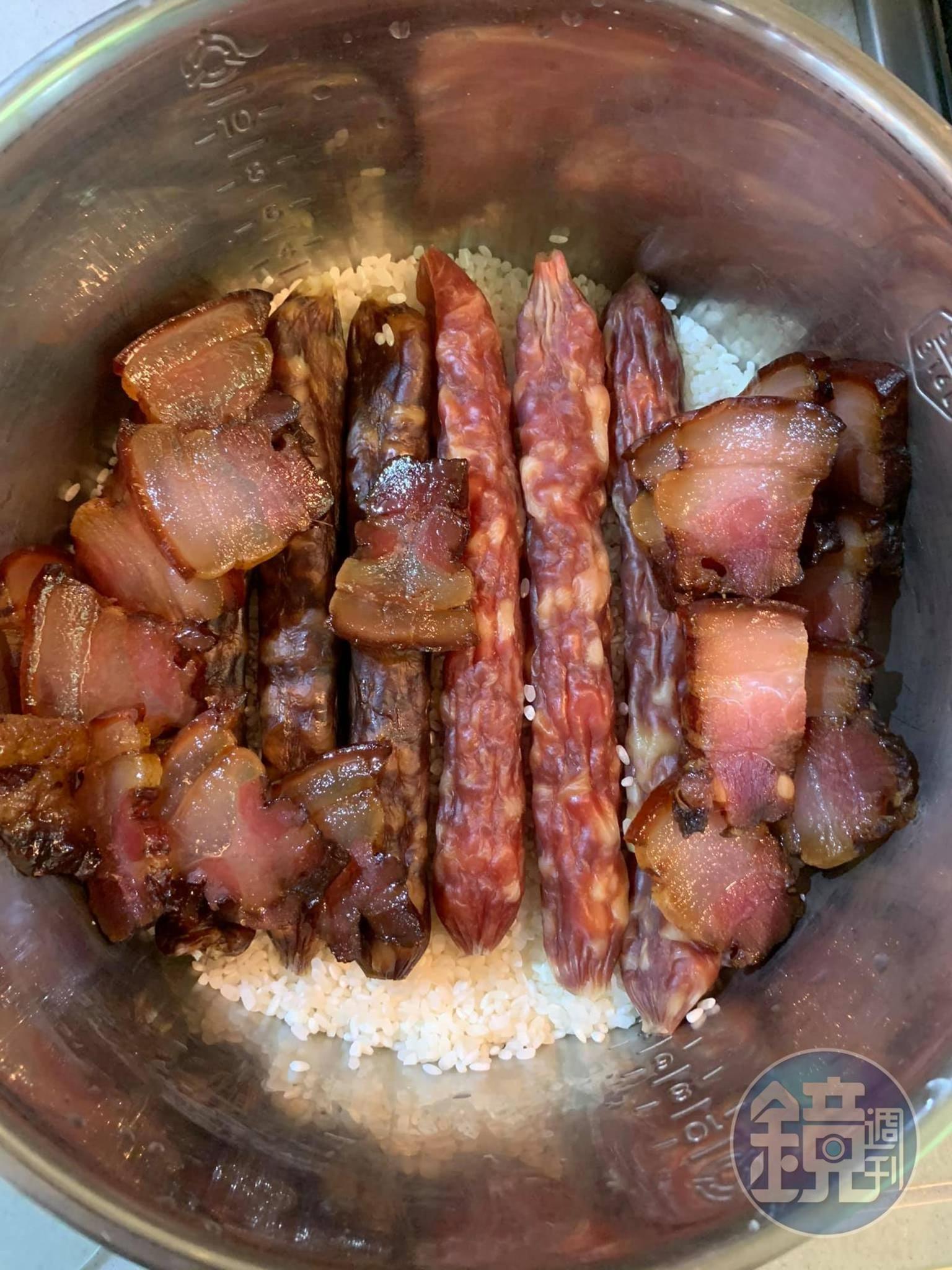 將臘腸、肝腸、臘肉放在米上,之後再加水。