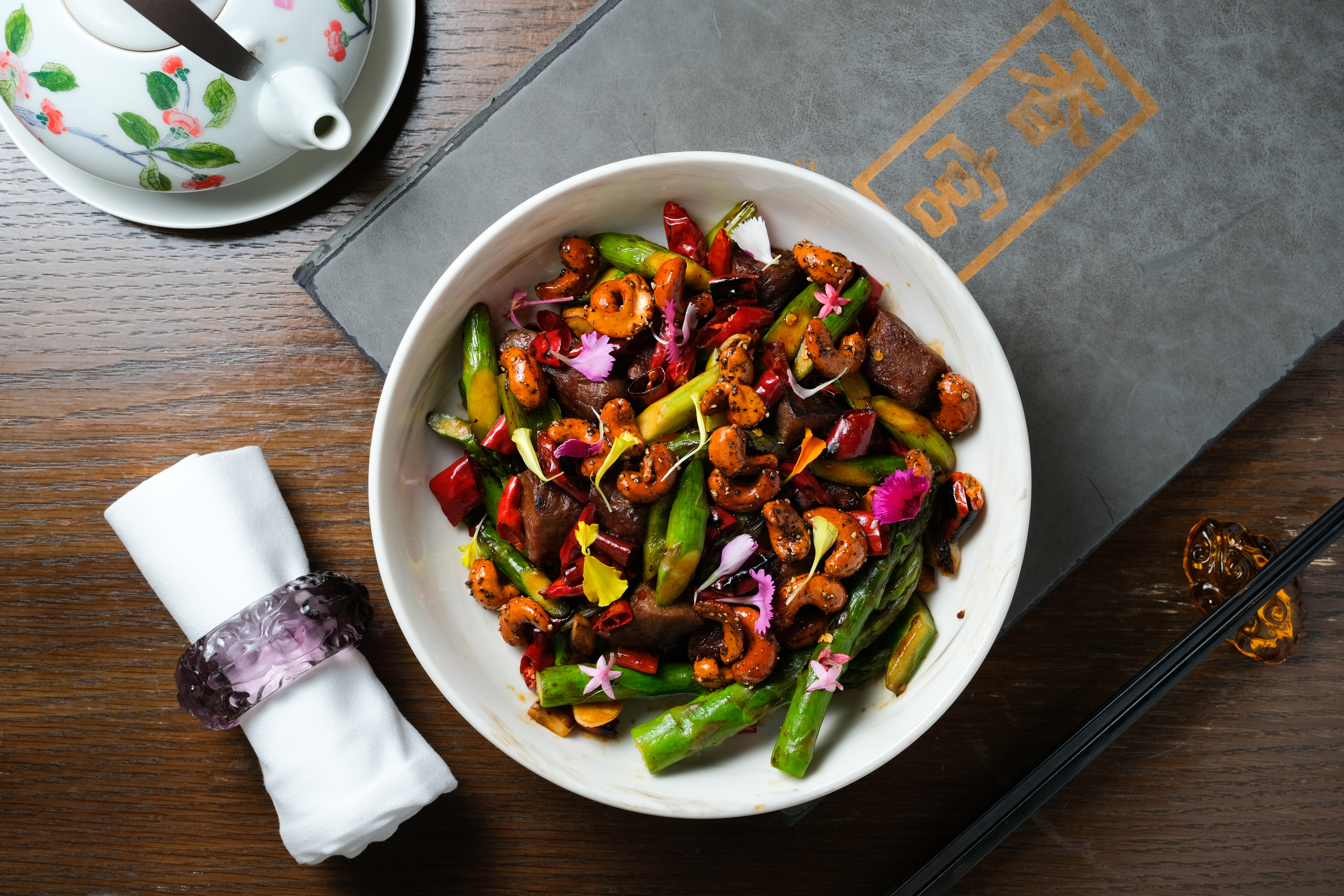 何競業主廚拿手的得獎之作「香辣蘆筍牛柳粒」，除了外脆內嫩的牛肉之外，黑胡椒焦糖腰果更是神來之筆。（1,188元／份）