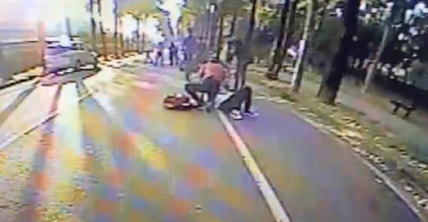 屏東監獄門口發生會客菜業者送完會客菜後，走出大門時，遭不明人士打傷，倒在地上。（翻攝畫面）