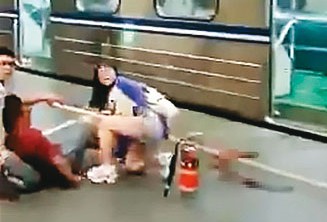 受傷乘客逃出台鐵車廂,在月台上等待救援。(讀者提供)