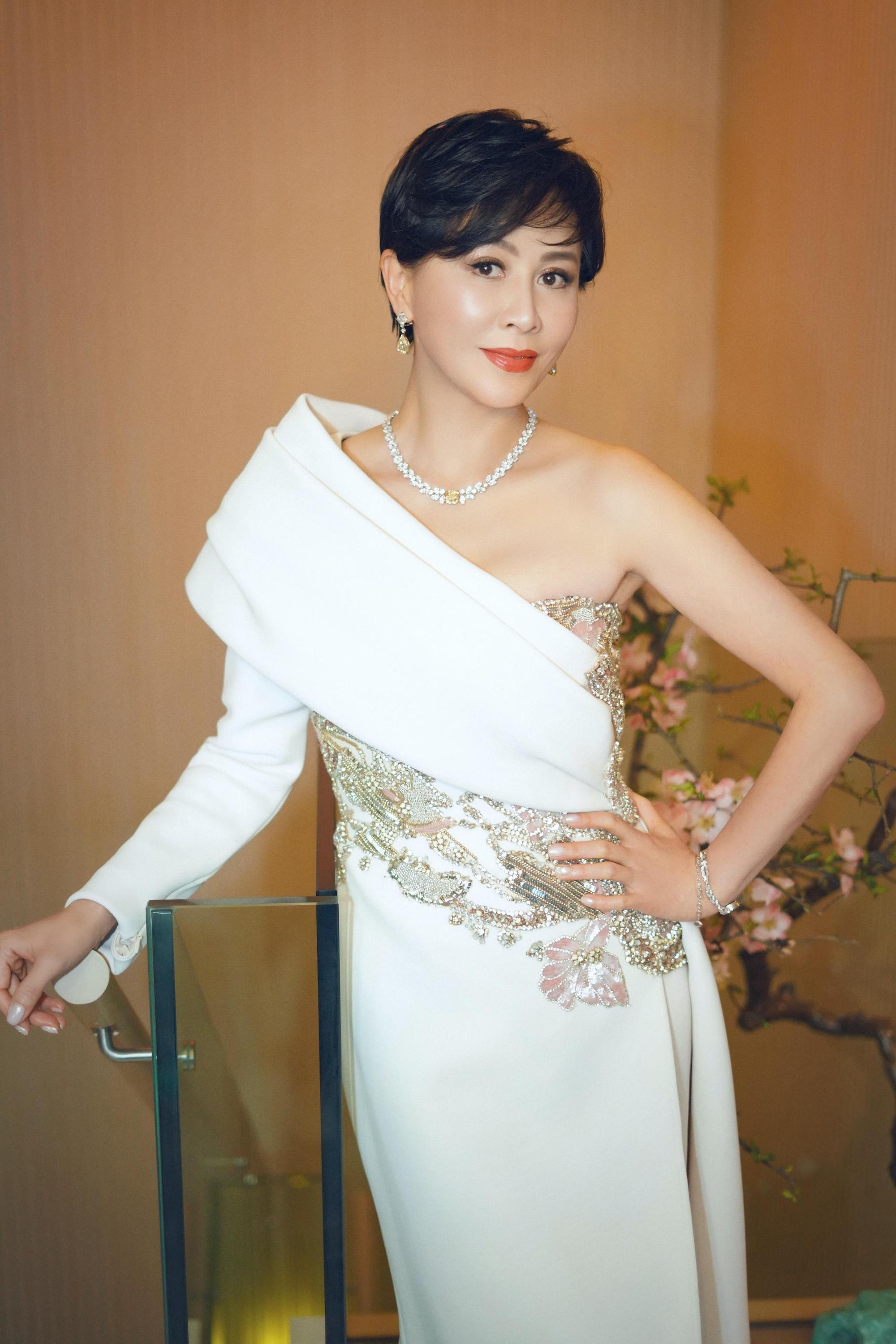 劉嘉玲身穿Elie Saab斜肩不對稱高訂禮服,以鑲嵌2顆總重約23.07克拉的水滴型黃鑽耳環增色,而Mini Twist頂級珠寶腕錶似一條蜿蜒的鑽石小河,在手腕流淌。(Harry Winston提供)